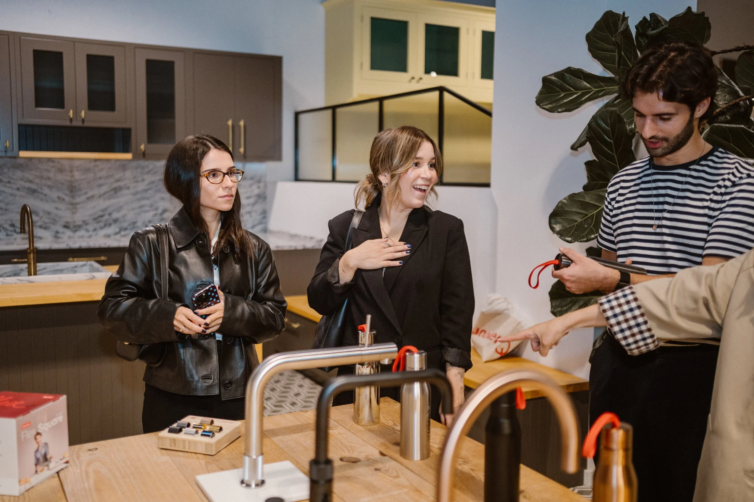 Event photography capturing natural networking moments between attendees during a professional event.