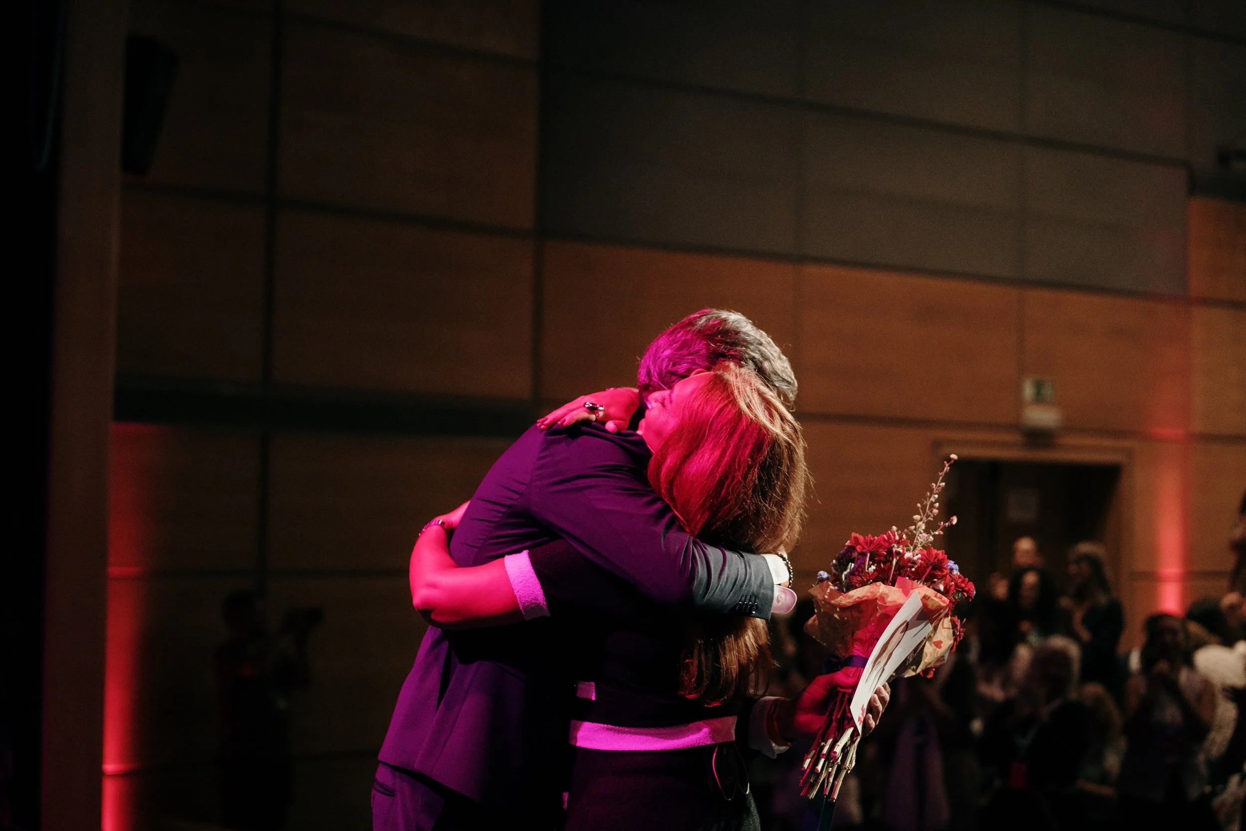 Photography of a hug at a corporate event