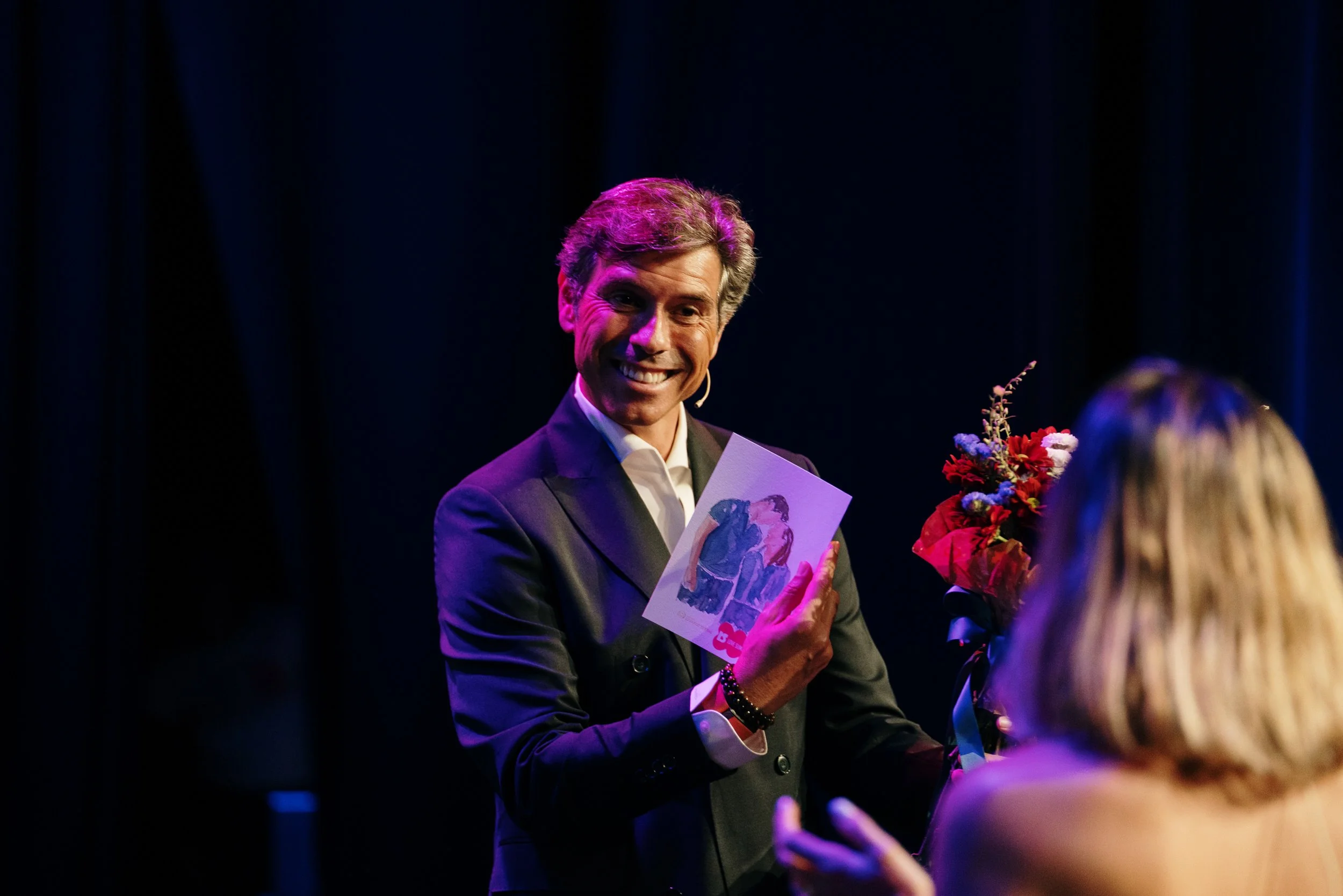 Corporate event photography capturing a speaker on stage during a professional conference in Lisbon.