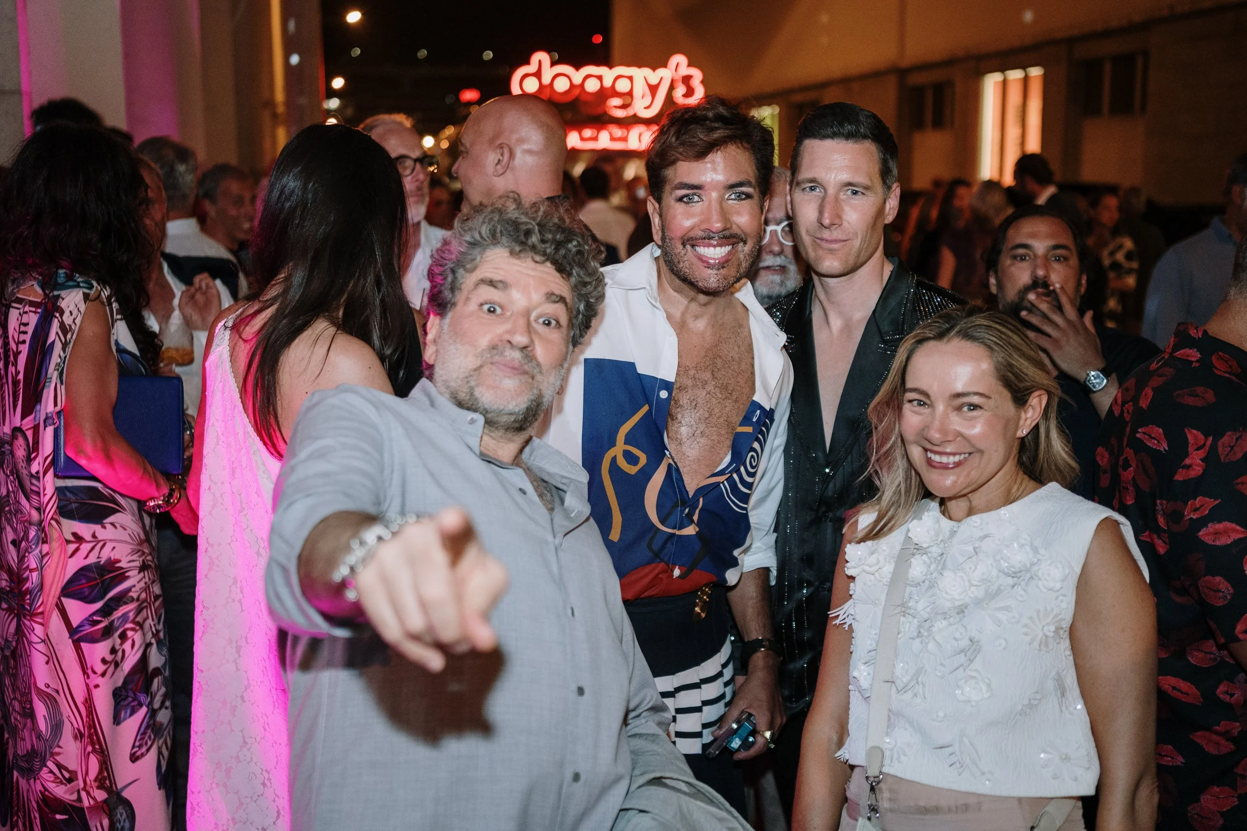 Event photography showing groups of attendees enjoying a shared moment during a live event.