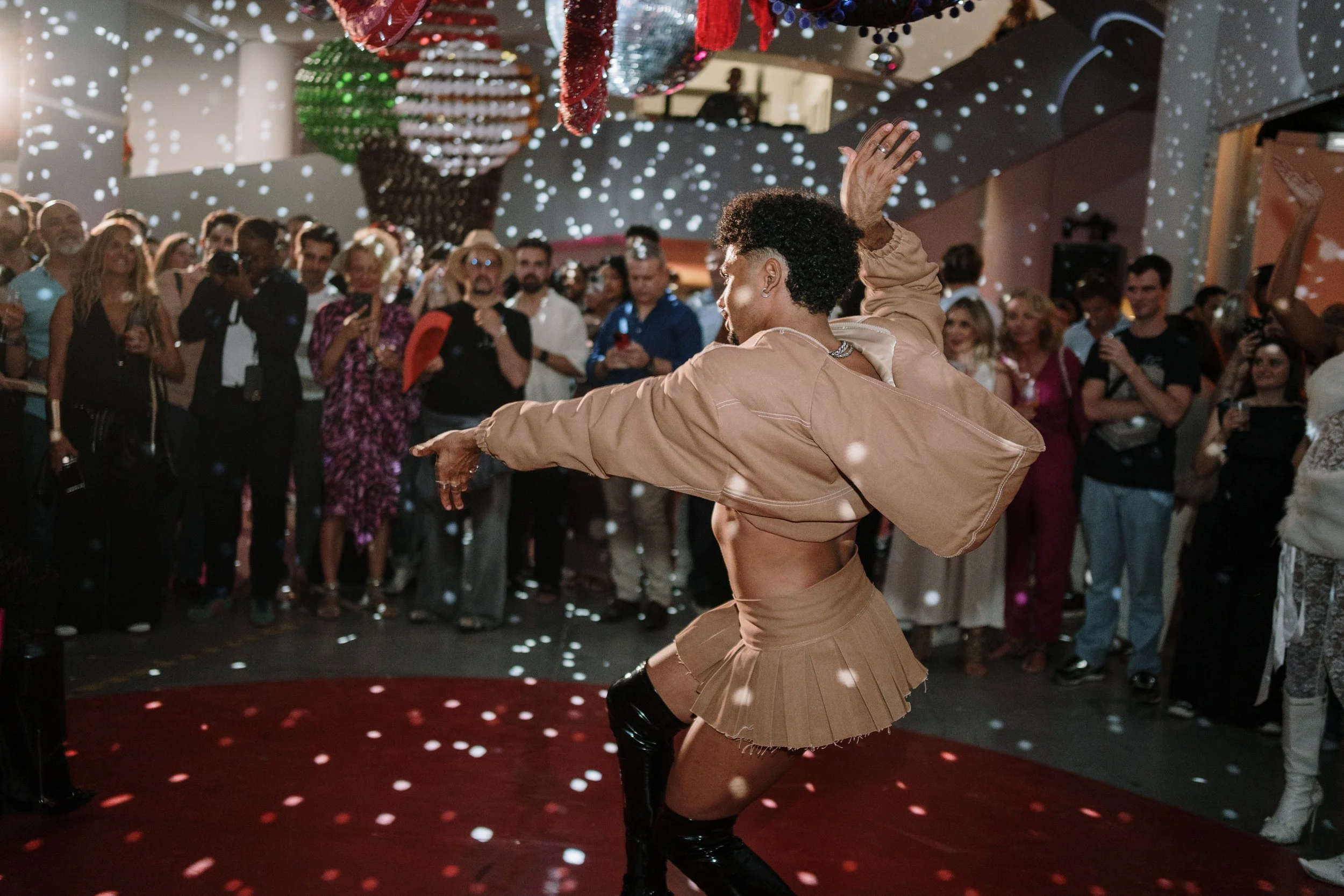 Event photography capturing a lively celebration with guests dancing and enjoying the atmosphere.