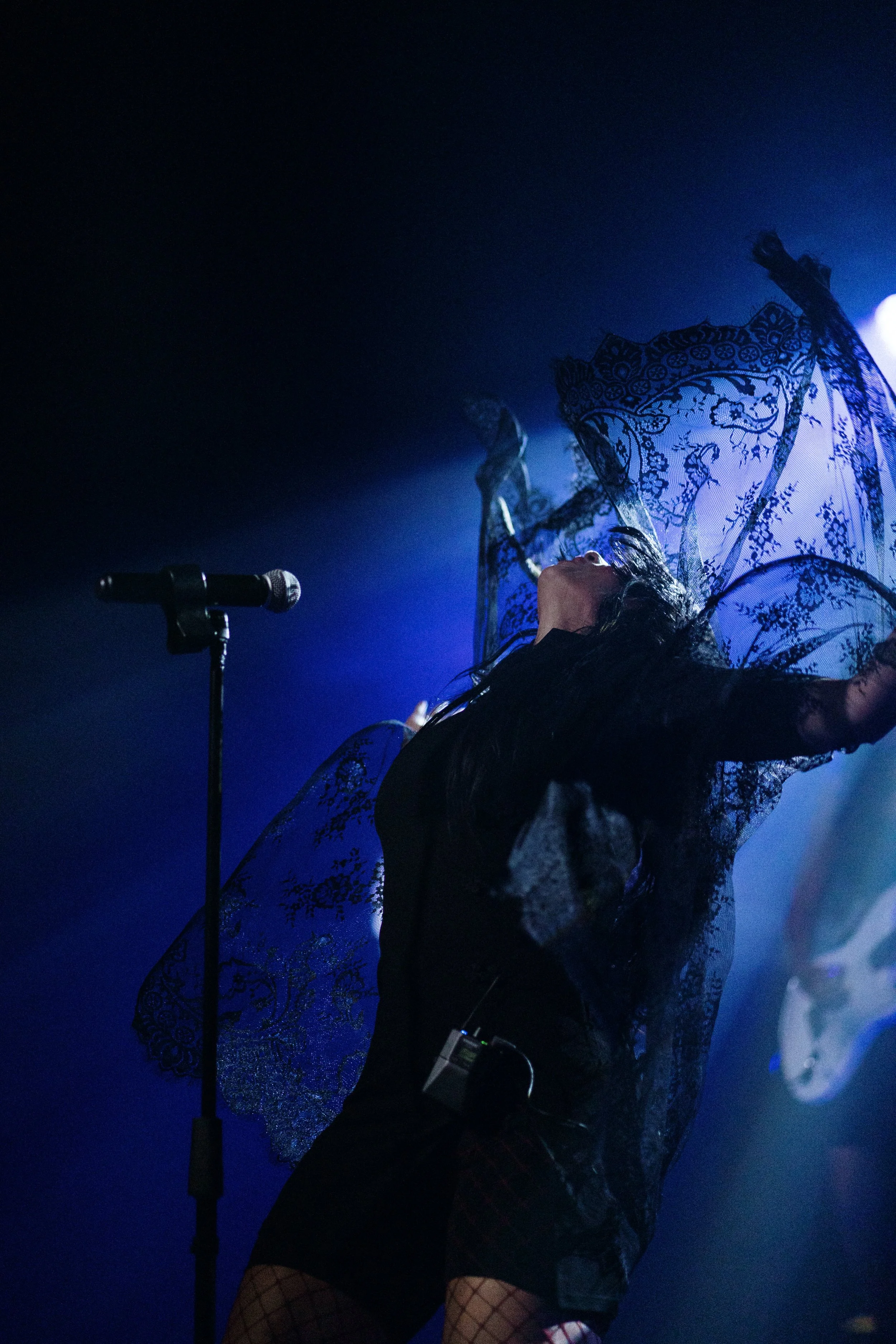 Event photography documenting a performer on stage during a live show or presentation.