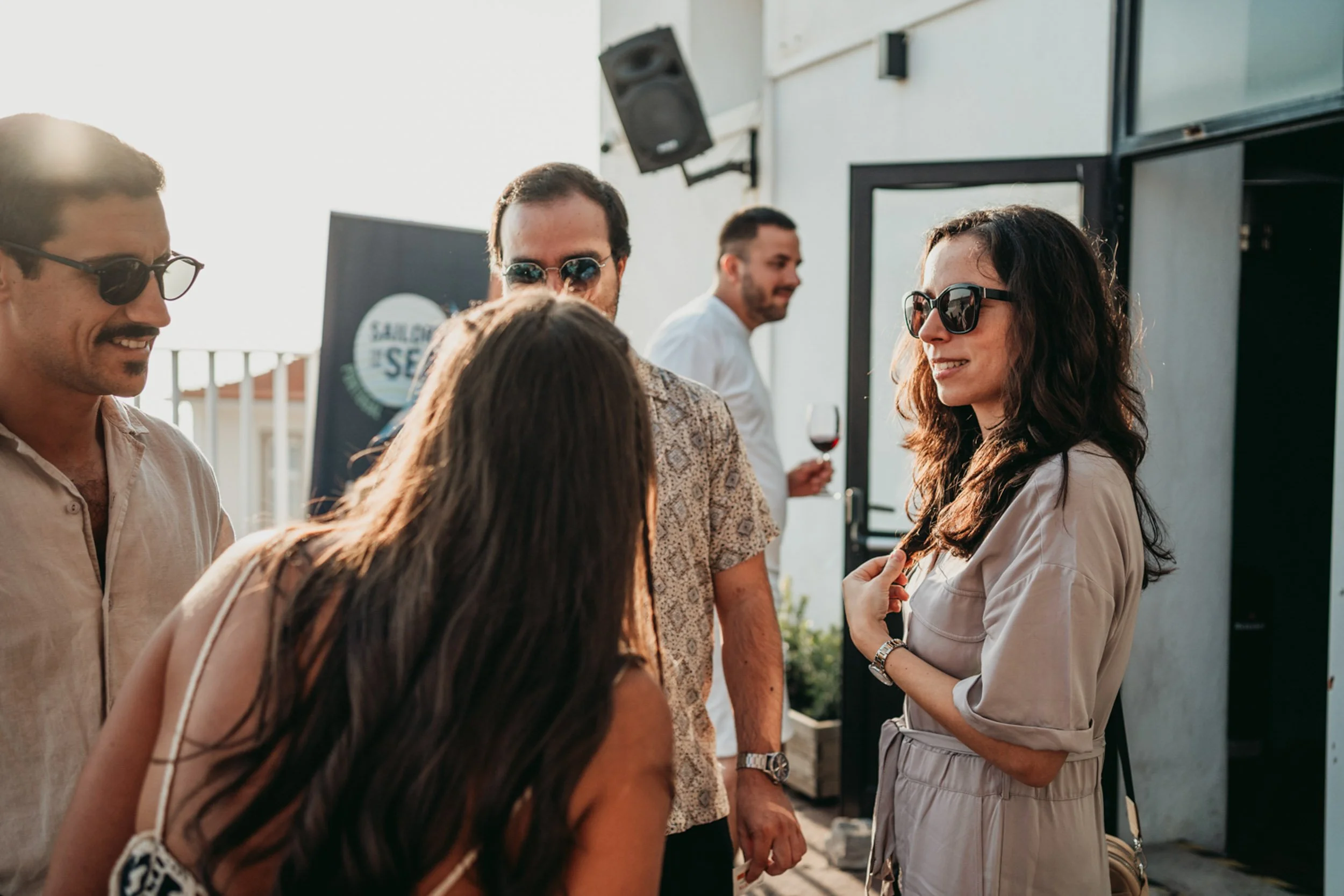 People arriving at a sunset wine party