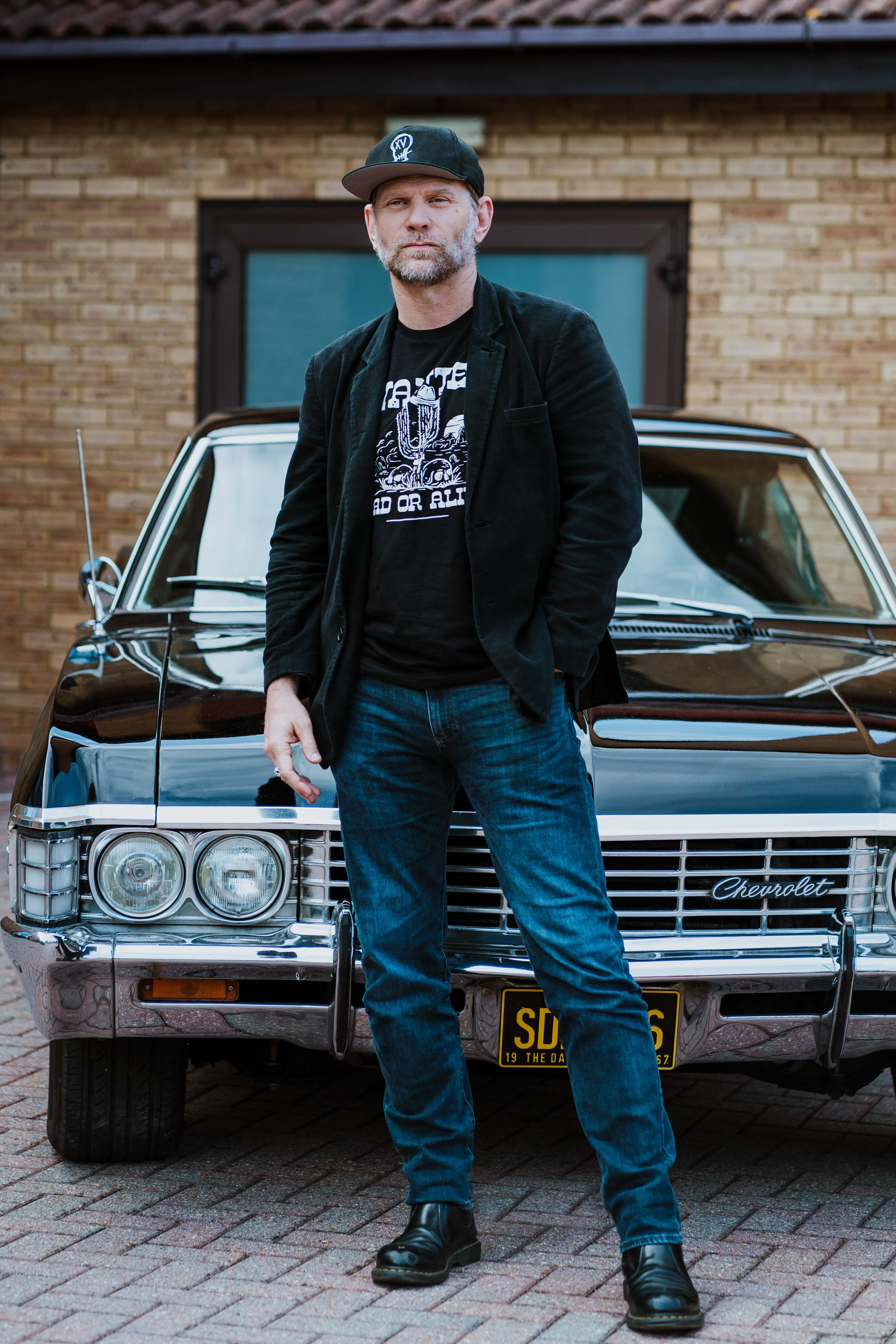 Mark Pellegrino posing in an Impala '67