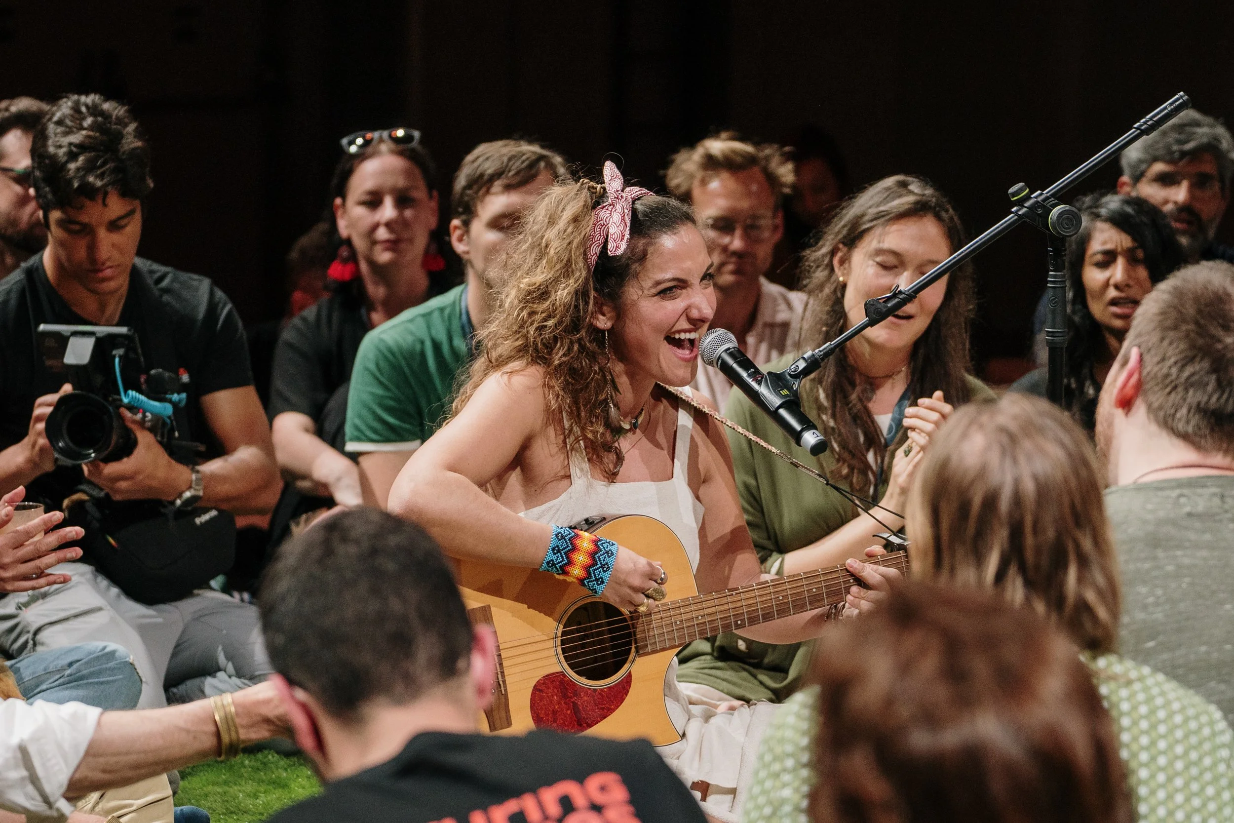 Live event photography capturing a music performance on stage with audience engagement.