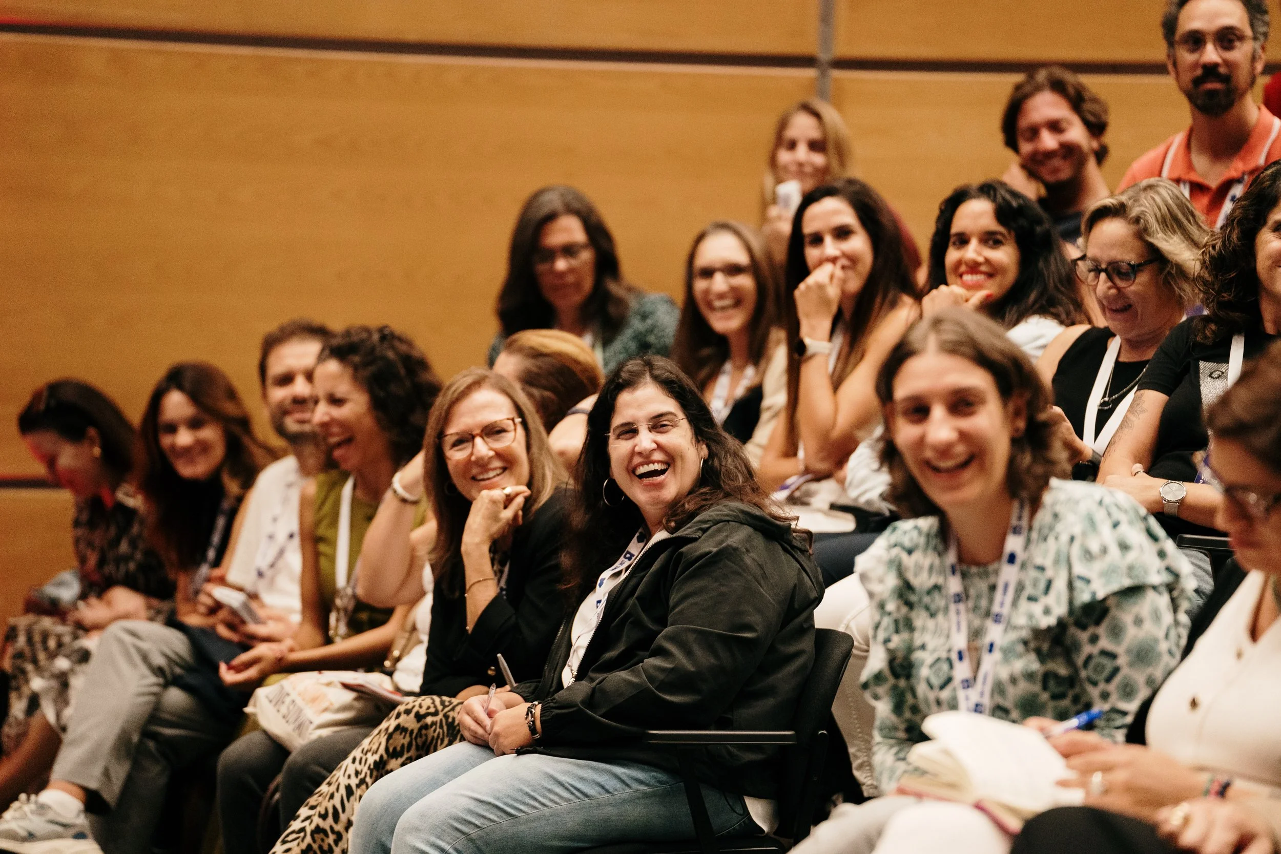 Event photography showing attendees engaged during a conference, capturing atmosphere and interaction.