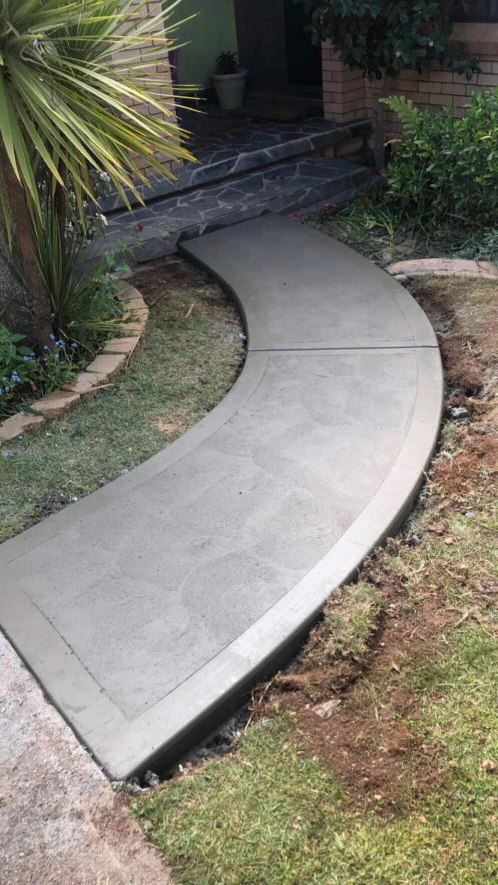 Pathway to entrance of house in West Bathurst with a fish scale cove finish