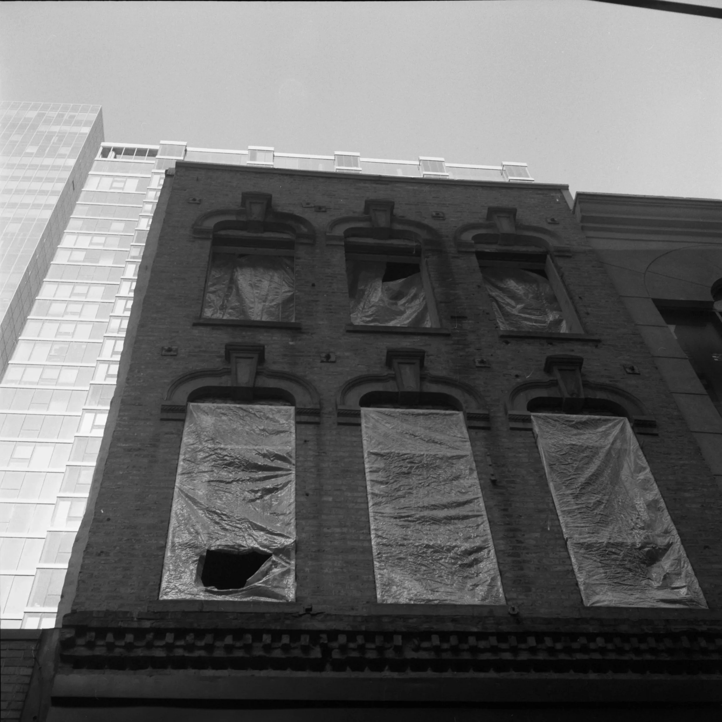 Deliberately neglected 1880s Italianate buildings on Wells St, 2024. (Since restored!)