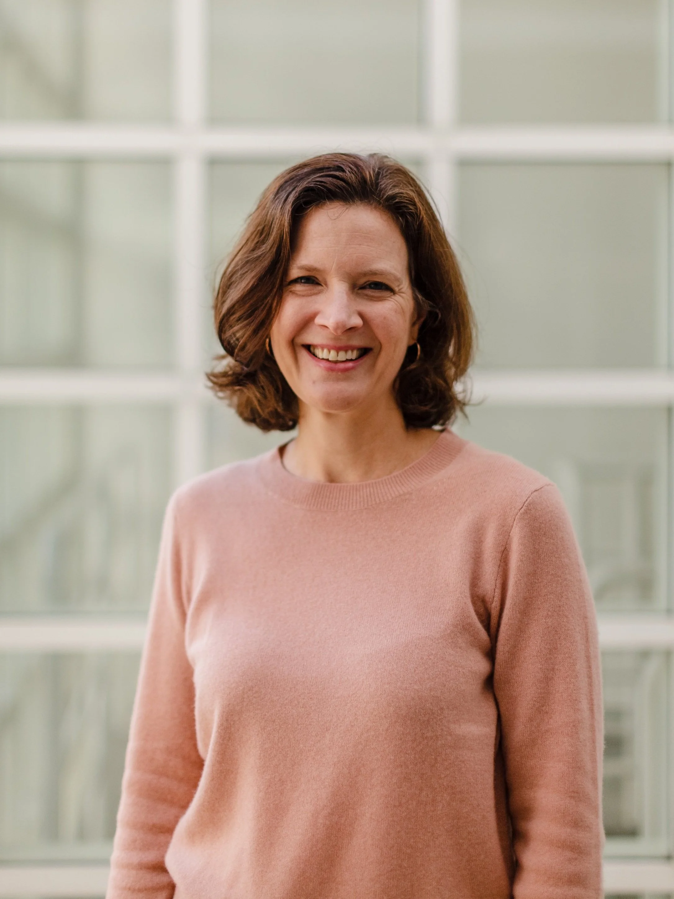 Kate Christman smiling in front of window | pregnancy care