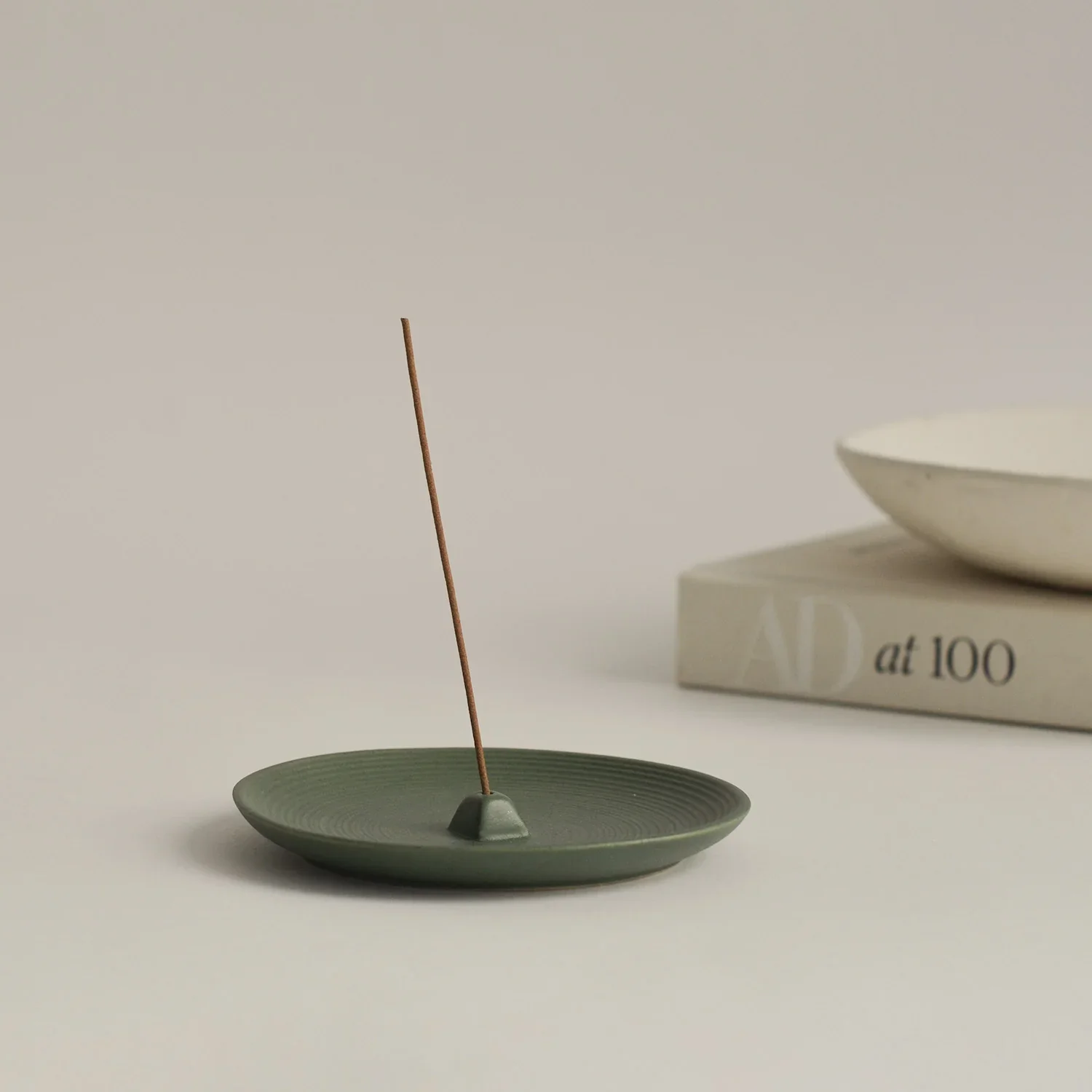 green_ceramic_incense_holder_with_incense.webp