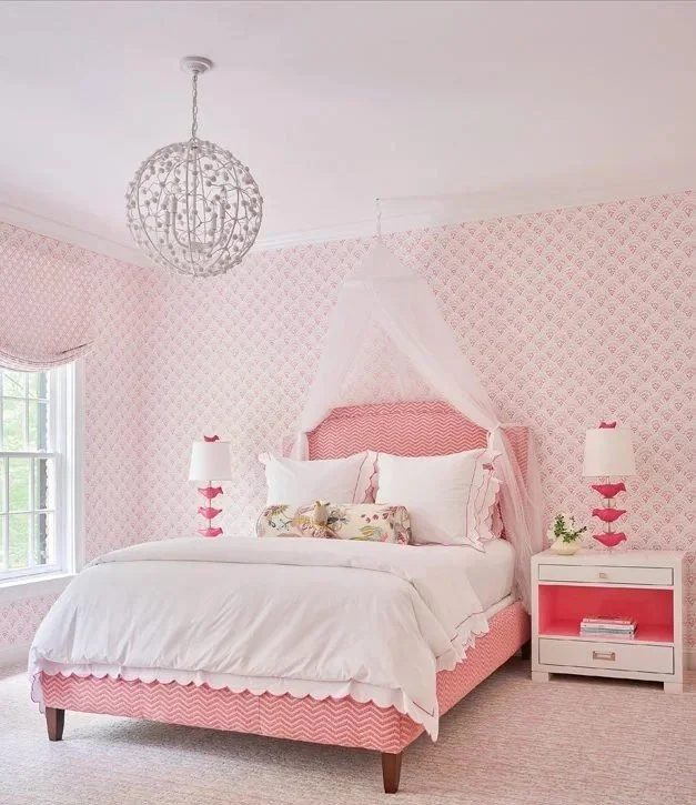 Pink children’s bedroom designed by Georgia Zikas with scalloped wallpaper, soft furnishings, and layered textures