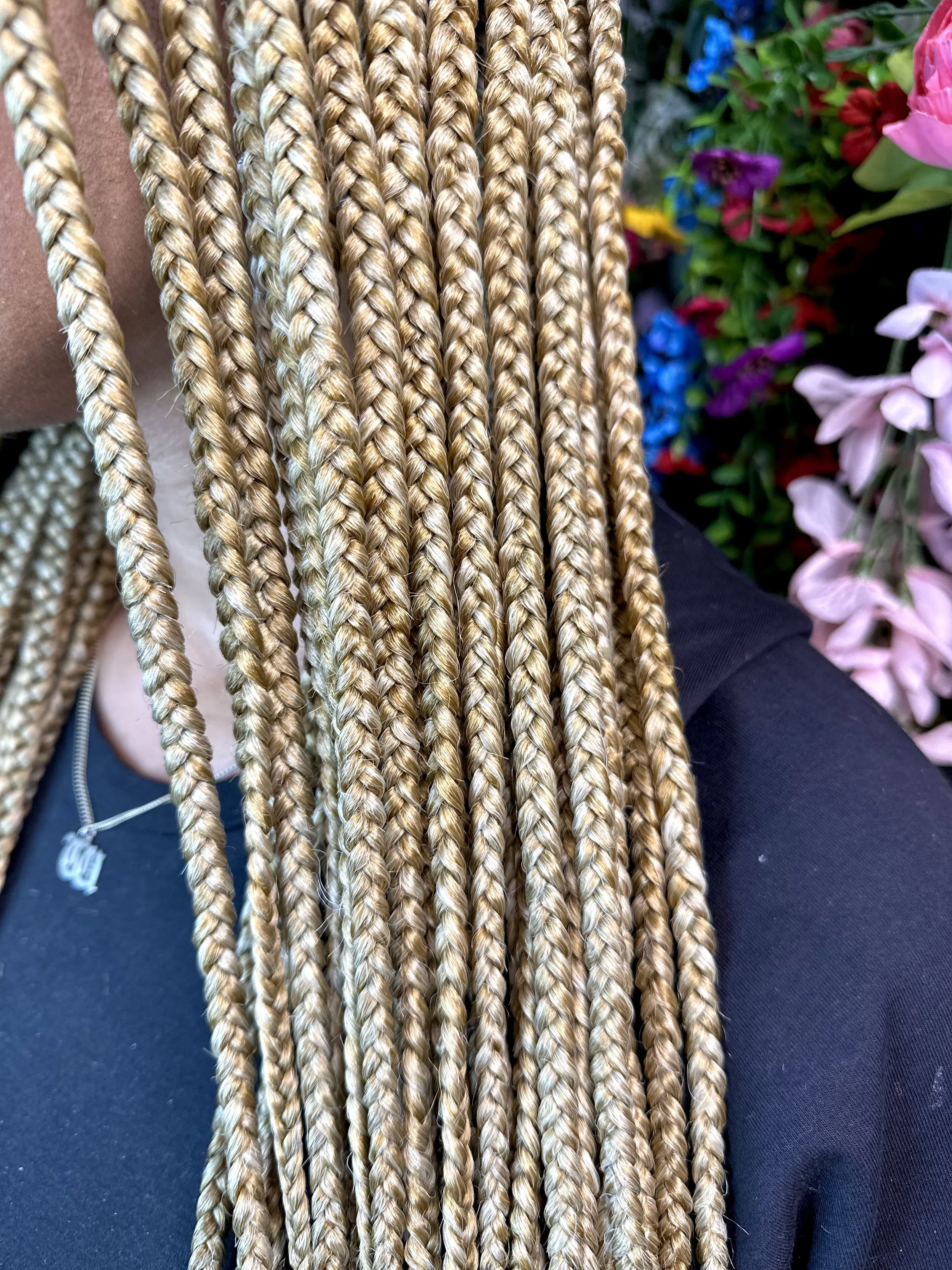 White and golden blonde braiding hair mixed together on brown skin