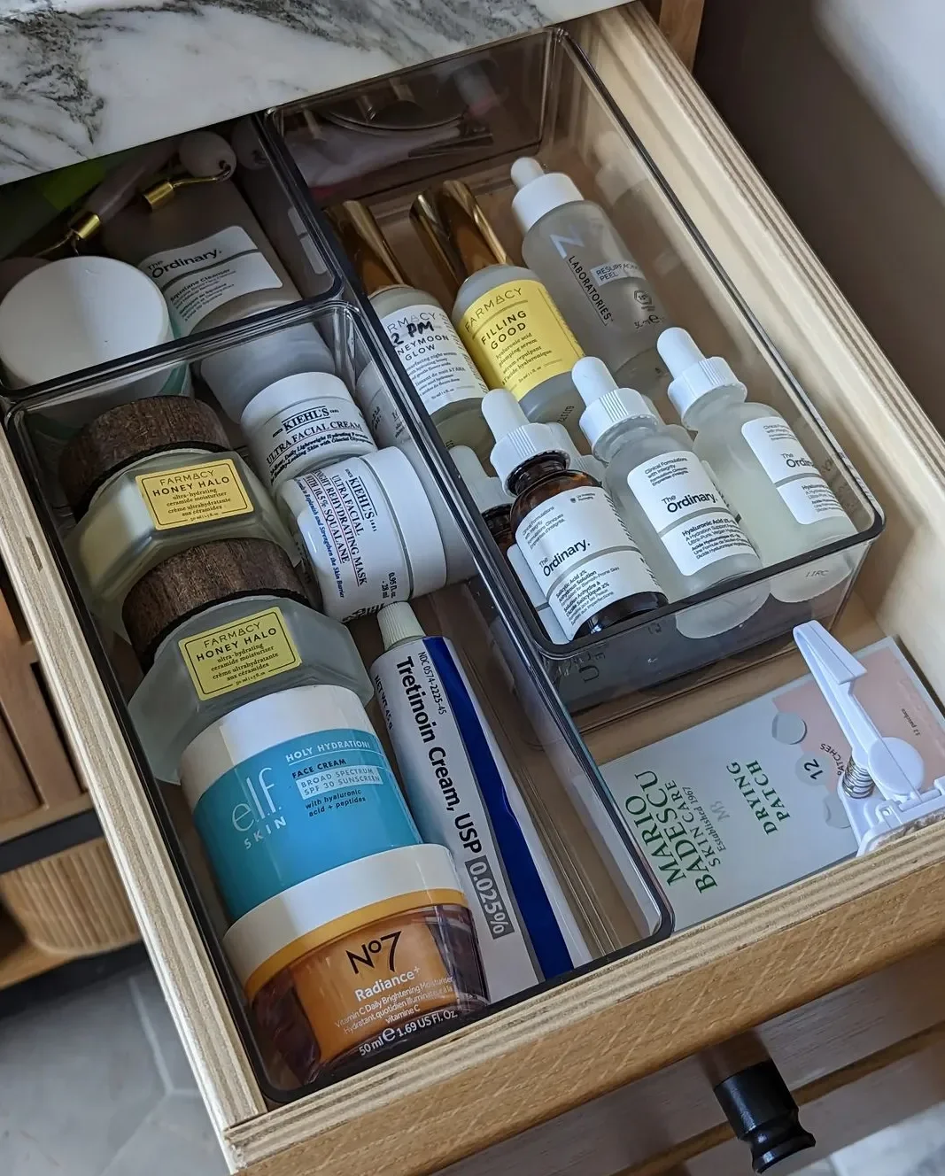 Neatly organized bathroom drawer with skincare products arranged in wooden dividers, Hudson Valley home organizer