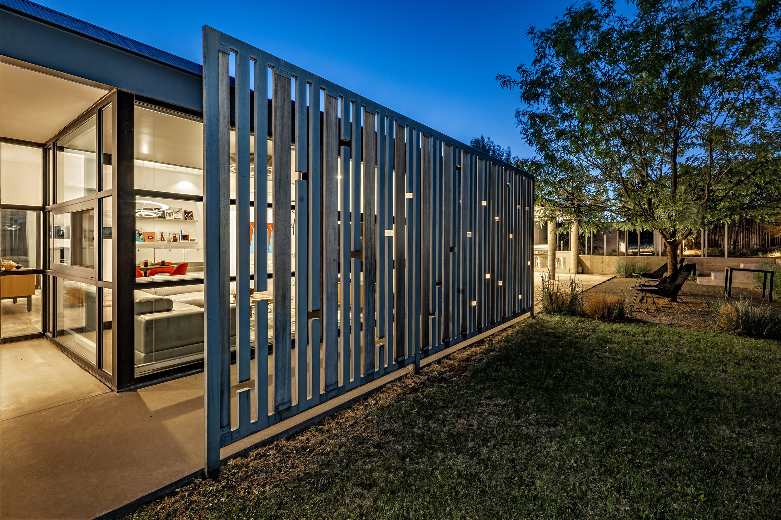Exterior sculptural fence at dusk at contemporary house in Santa Fe