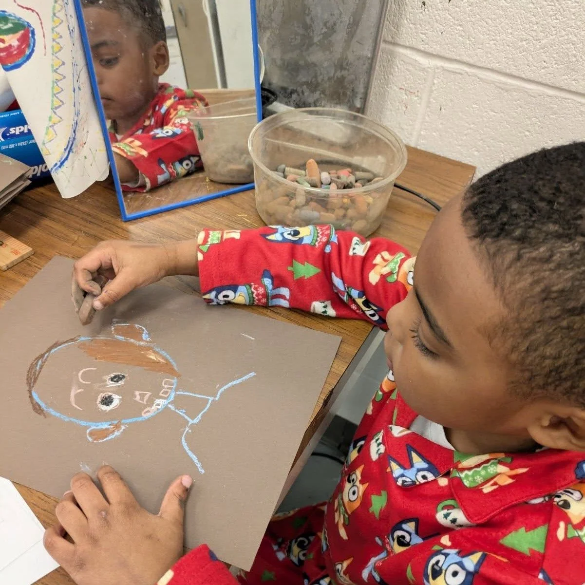 "When I look in the mirror, what do I see? A beautiful somebody looking back at me." 

This CPS mantra rings true in our art class as students create self portraits rooted in reflection and confidence. 

Pictured here, Tito carefully observ