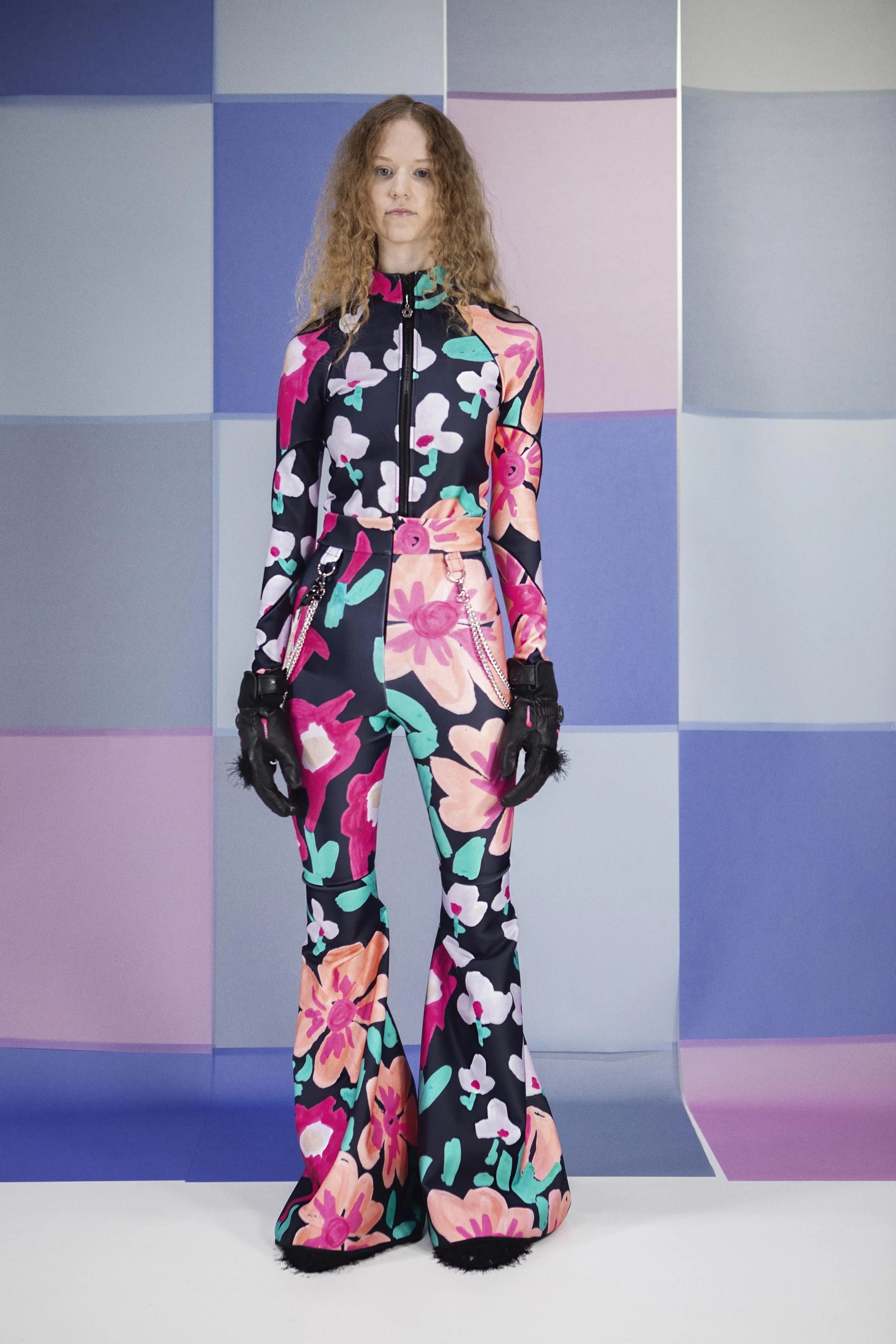 Model wearing gigantic flower and Tight fitting body and skipants made from scuba fabric with big flower print by Tuuli-Tytti Koivula