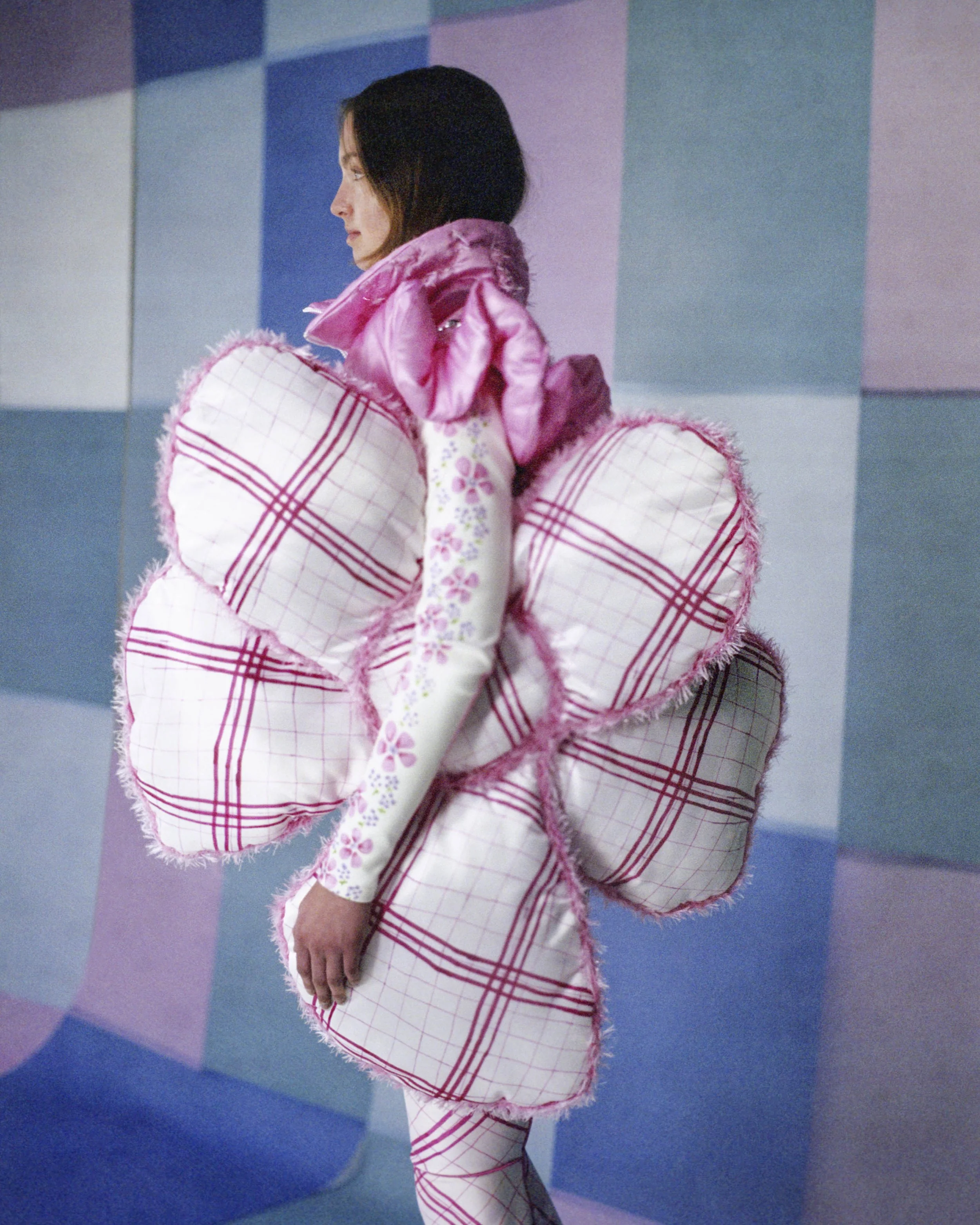 Model wearing gigantic flower and Tight fitting body and skipants made from scuba fabric with big flower print by Tuuli-Tytti Koivula