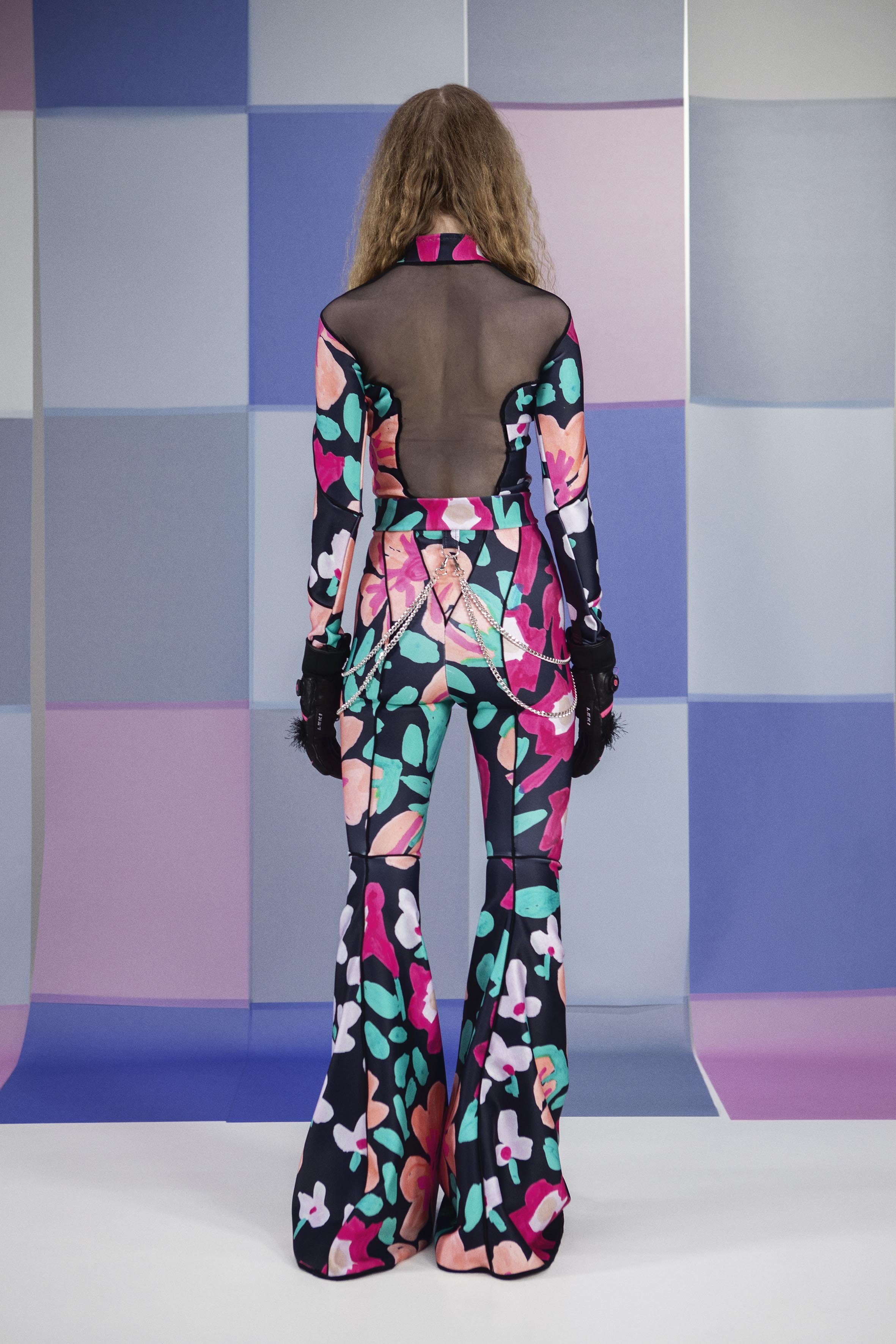 Model wearing gigantic flower and Tight fitting body and skipants made from scuba fabric with big flower print by Tuuli-Tytti Koivula