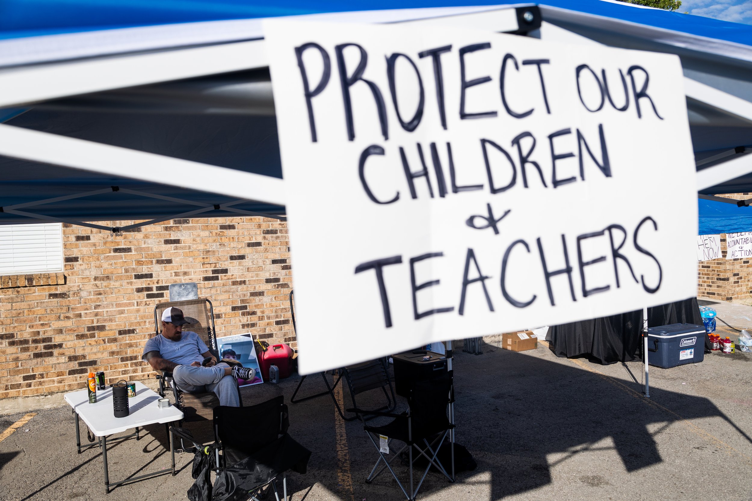  Brett Cross, the parental guardian of one of Uziyah Garcia, sits outside the back entrance of the Uvalde CISD administrative office building in the early morning of Oct. 4, 2022. Cross has been protesting outside of the building for over a week, cal