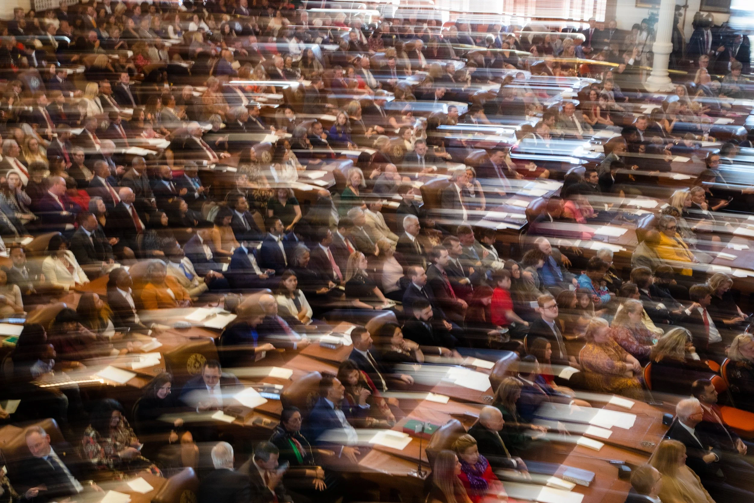  State Representatives and their families sit on the House floor on the opening day of the 88th Legislative Session at the state Capitol in Austin on Jan. 10, 2022. 