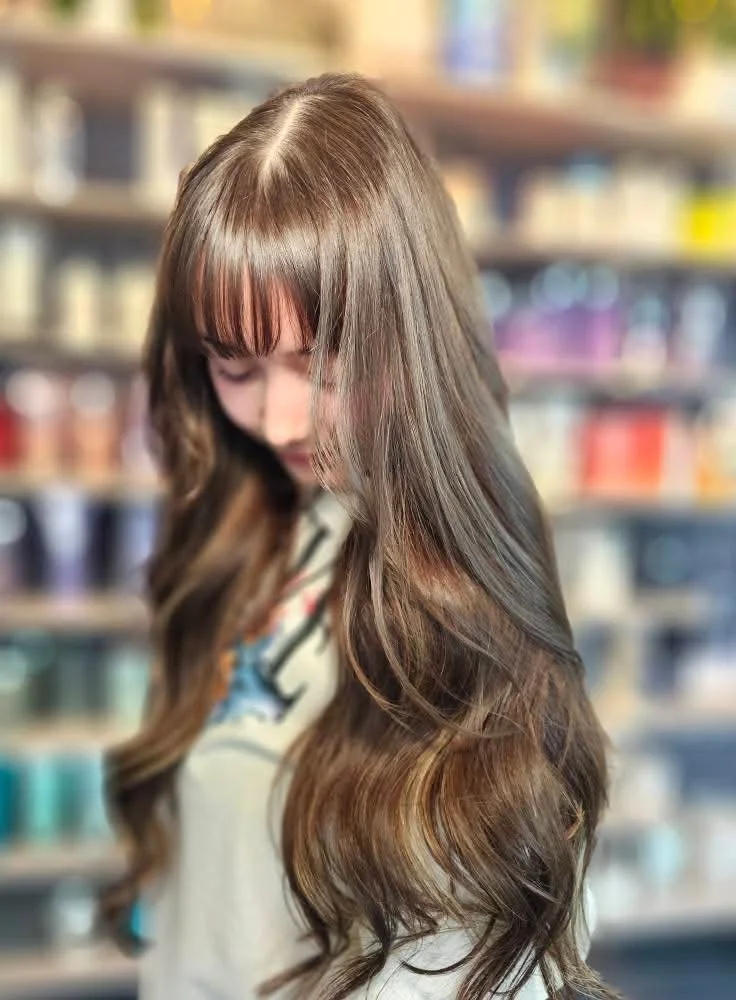 Seamless brunette hair extensions for added length and volume in Anchorage