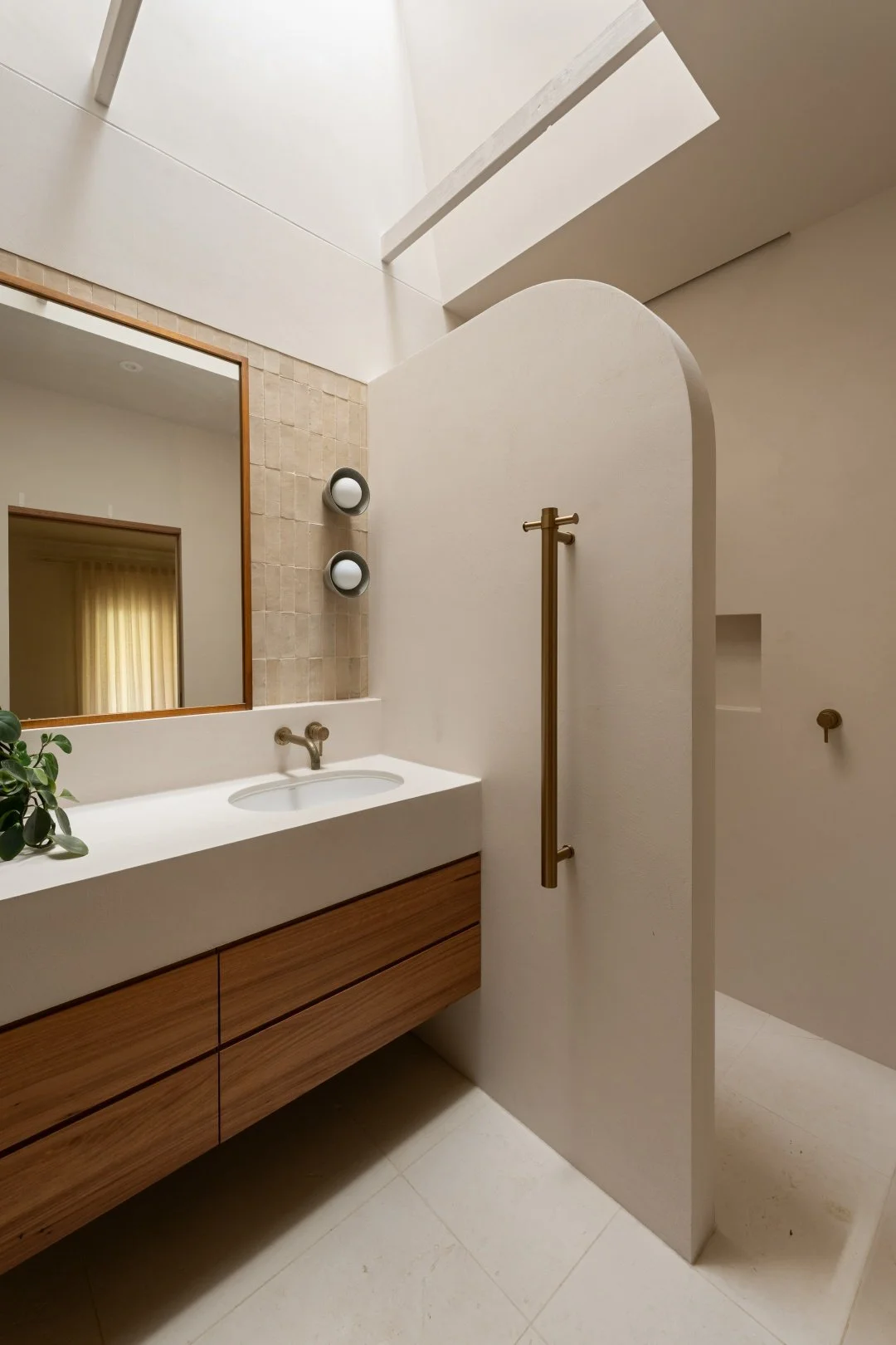 Ensuite niche wall seperates wet and dry areas whilst housing a heated towel rack.