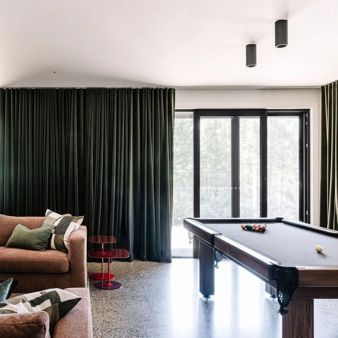 In the pool room, working with its polished concrete floor, we added a dramatic olive green velvet curtain. We had a 'ball' customising this pool table with Alcocks and working with the browns and terracottas of the home so that it fit snuggly into t