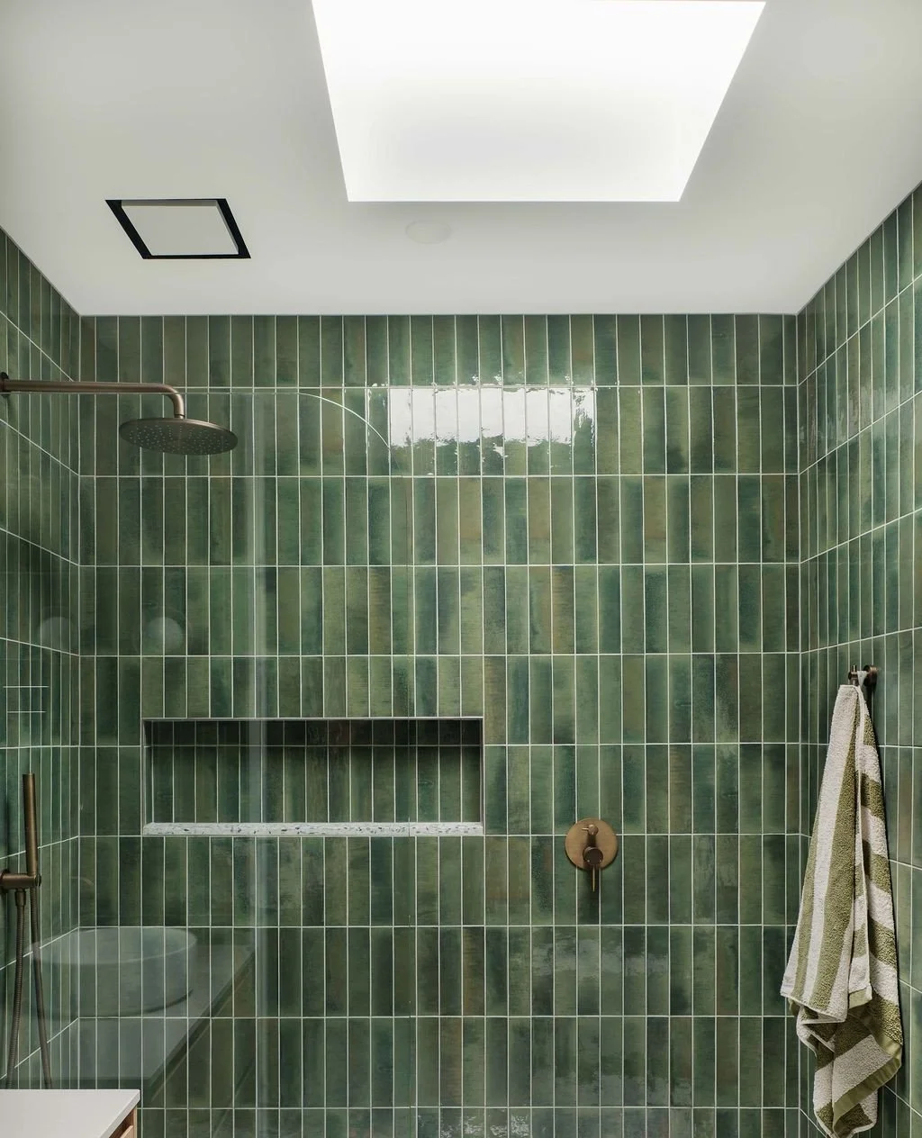 Who has a bathroom with no window? The biggest bang for buck is to see if your roofline can take a skylight. This lush green bathroom is in the middle of the house, and by adding a skylight, the room now has a HUGE amount of natural light. We then ad