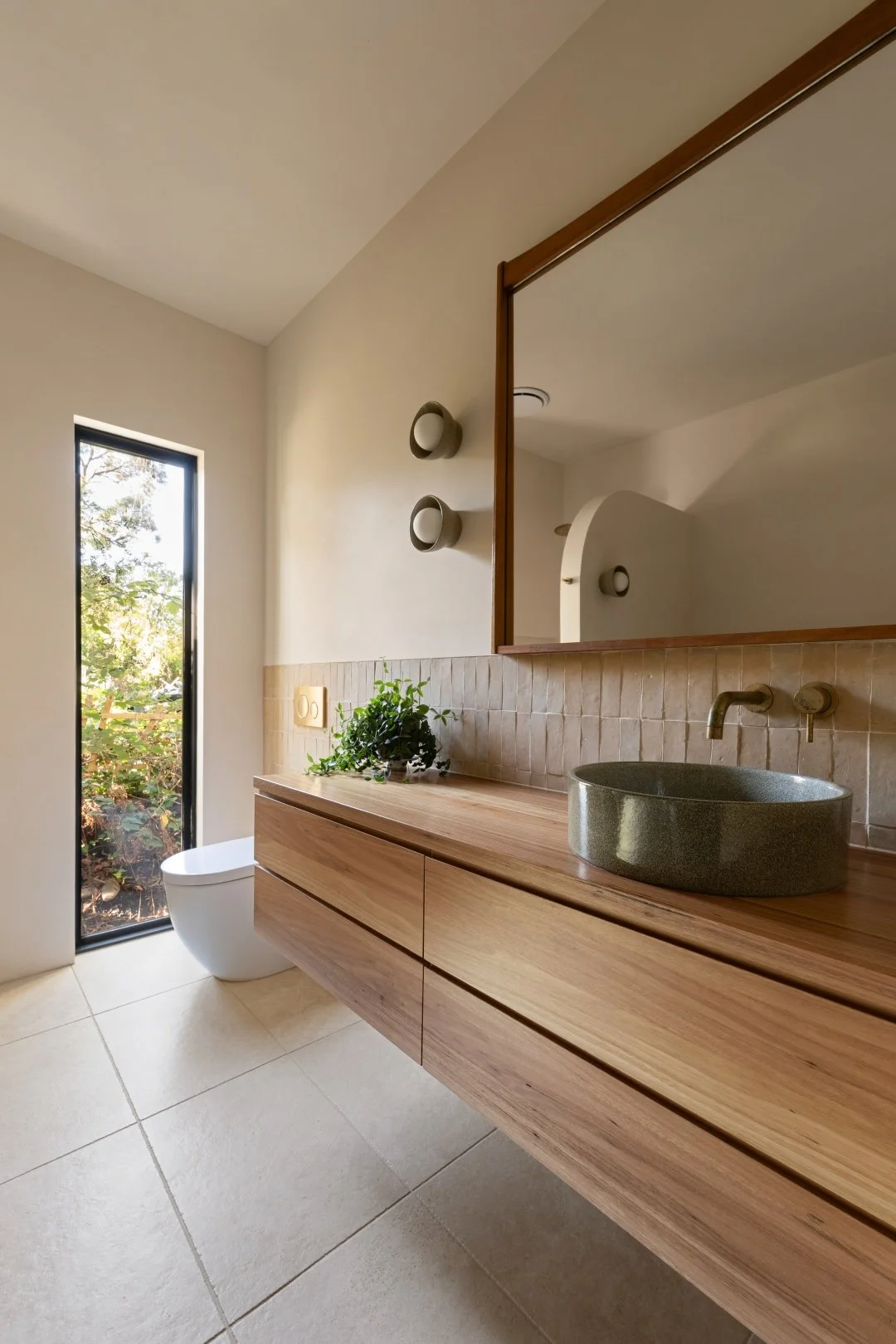 New double glazed window brings light in on the floor tiles in Jerusalem Stone by Aspire Ceramics.