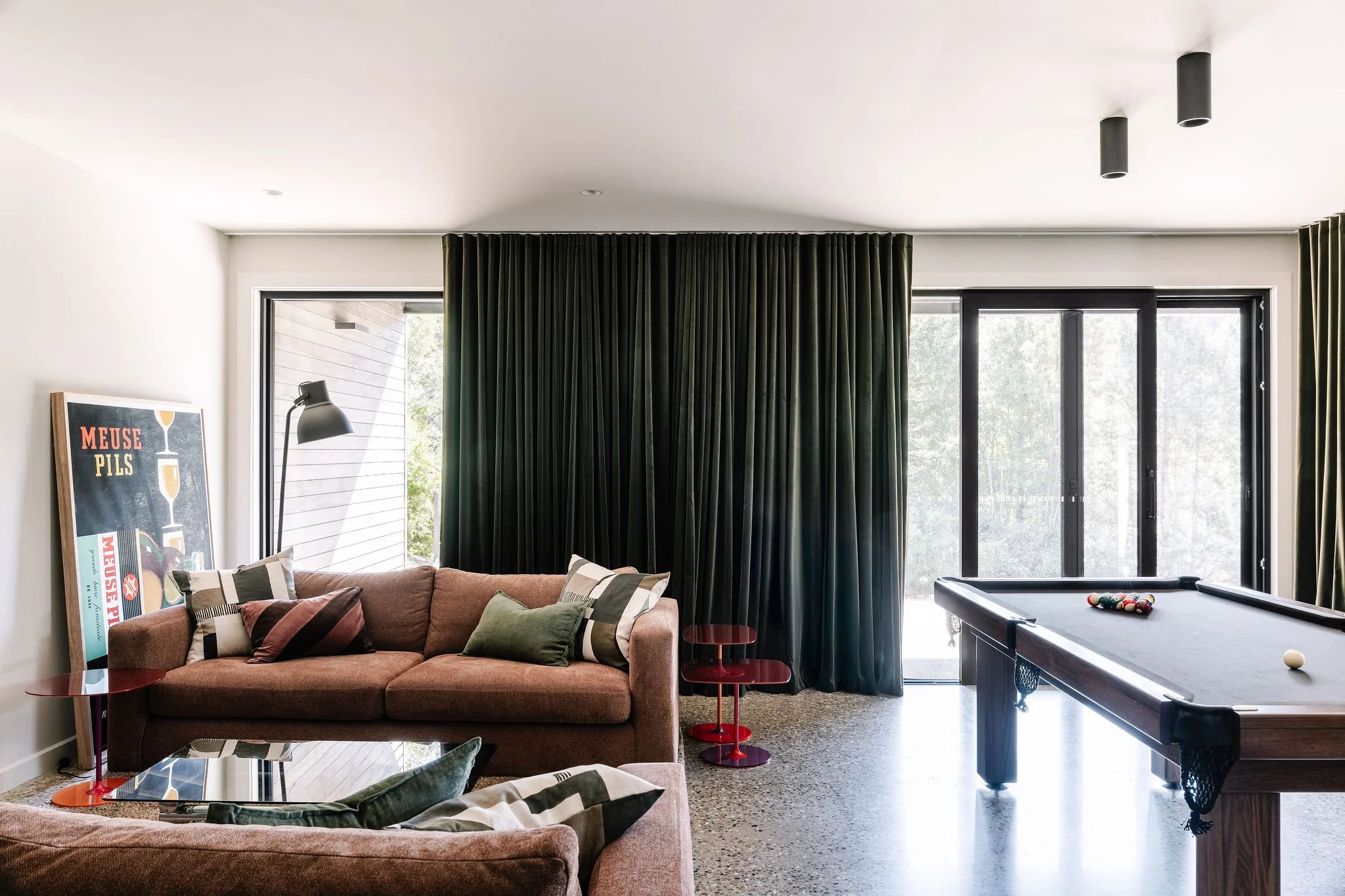 The downstairs Play Zone anchored by the pool table and sofas by Molmic