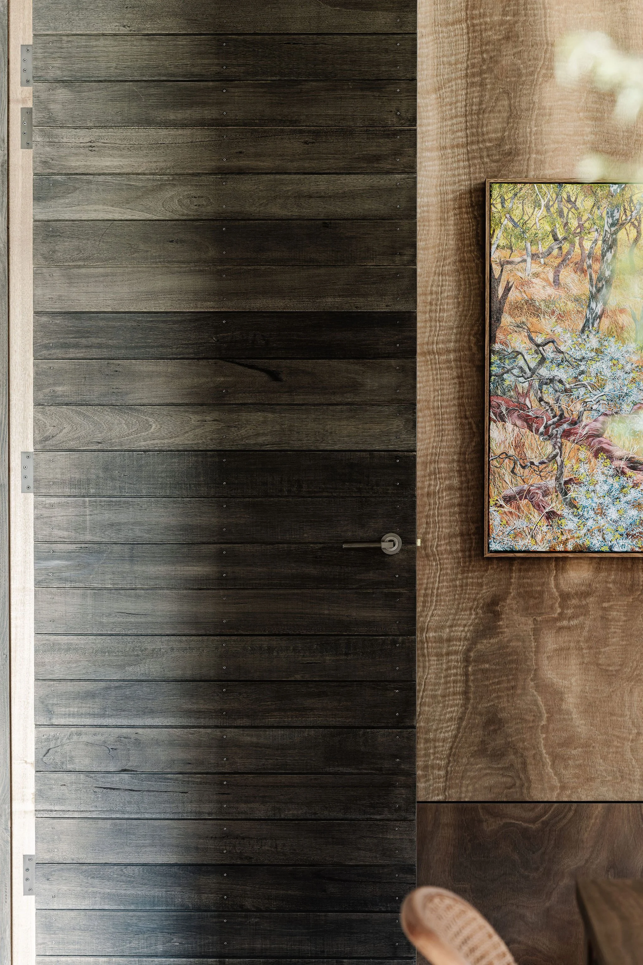 Wood-lined warmth and a touch of colour define the open plan space beyond