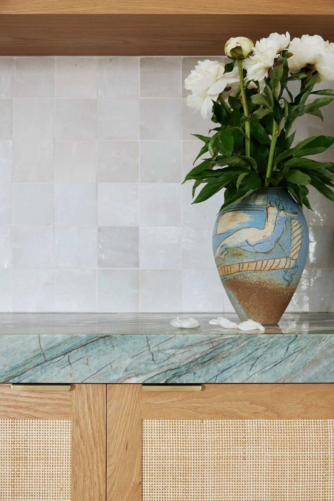 The gin bar of High Tide features the same marble slab as the adjacent kitchen