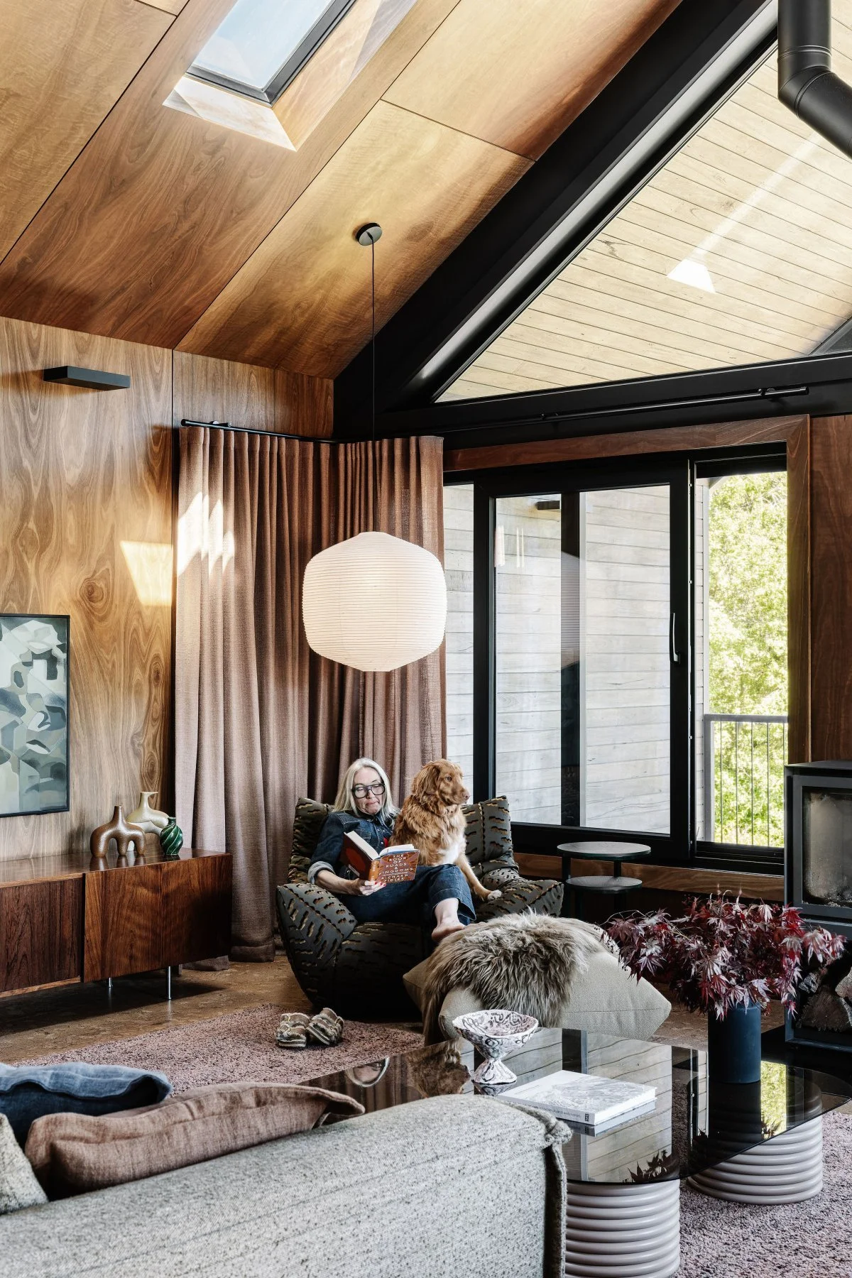 Nicole relaxes with her dog in the living room of Alpine Glow, by Britt White Studio