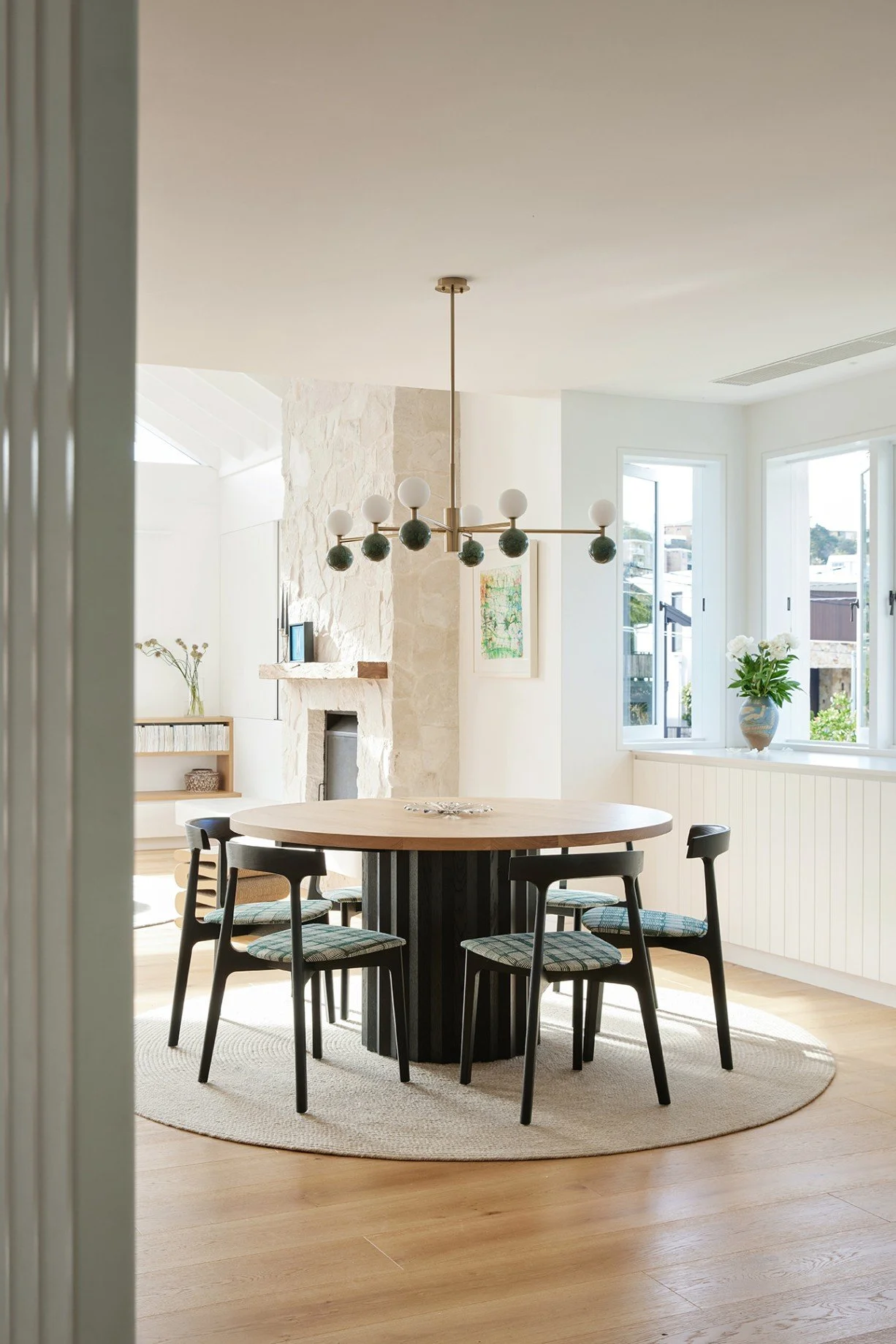 The High Tide living room features a custom Mark Tuckey table, custom Apparent chairs, Armadillo rug and Dalt pendant, defining the space in an open plan location