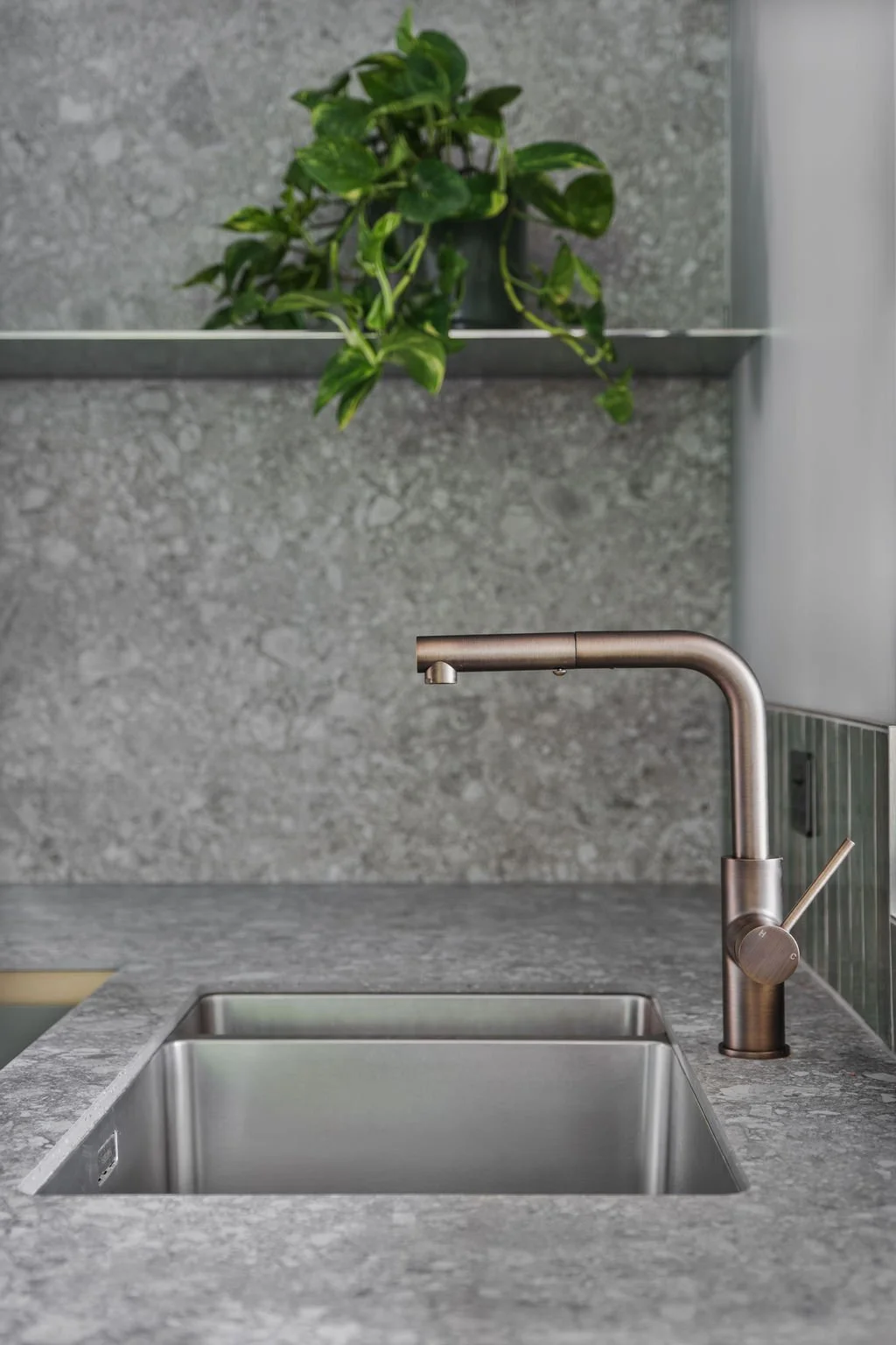 The stainless steel shelf reflects the light that comes in from the Eastern window, bouncing back from the tiled range hood.  