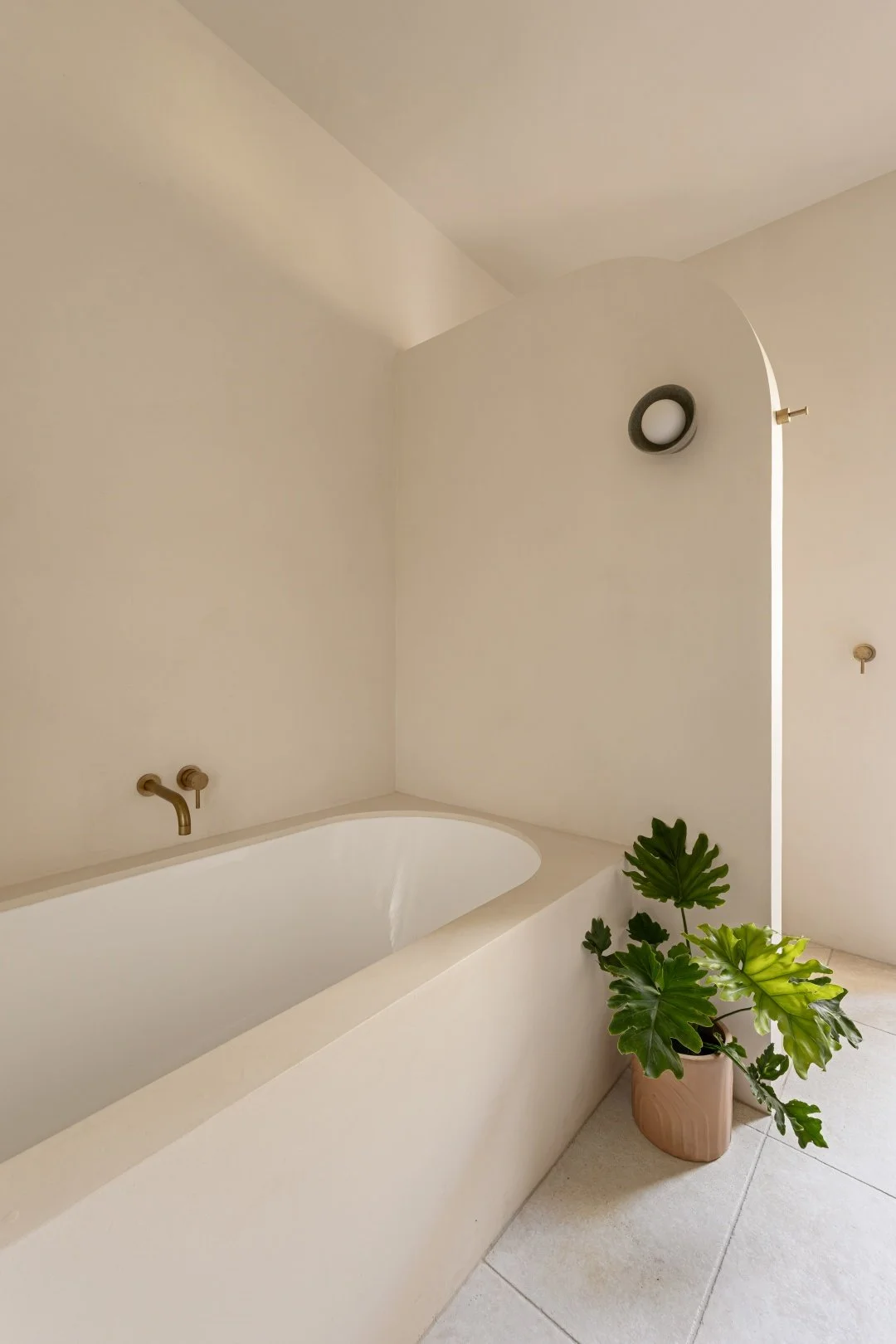 Main bathroom also features an inset bath wrapped in microcement.