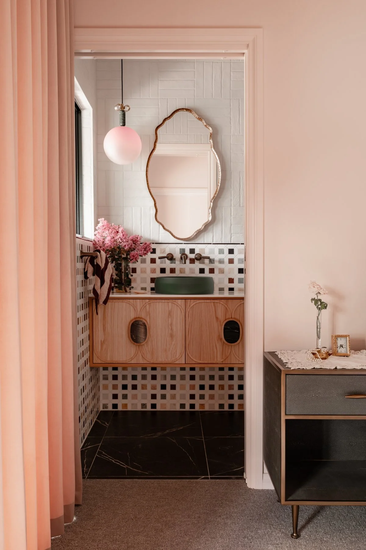 The ensuite carries the same language as the main bathroom, but in a quieter and more intimate manner.
