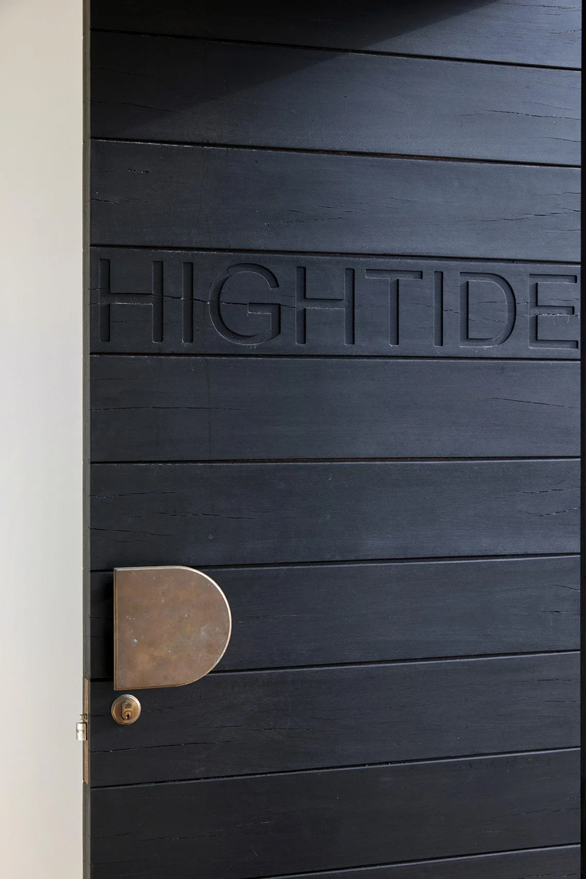 High Tide front door in charred timber with bronze hardware