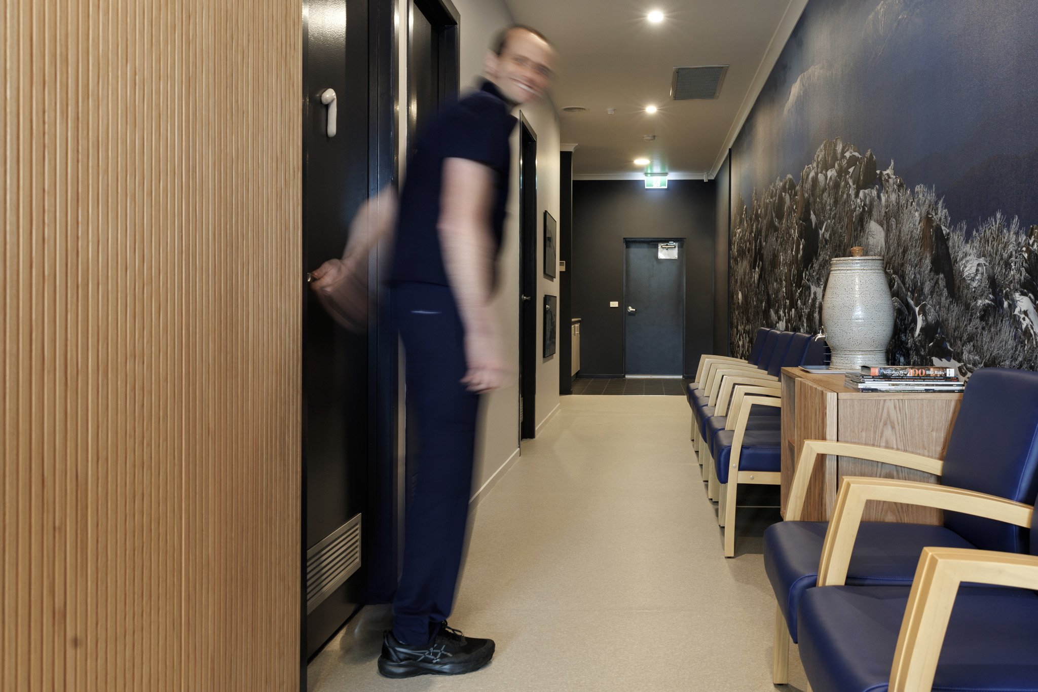 Paired with blue seating and natural oak finishes, the mural creates calm for patients.