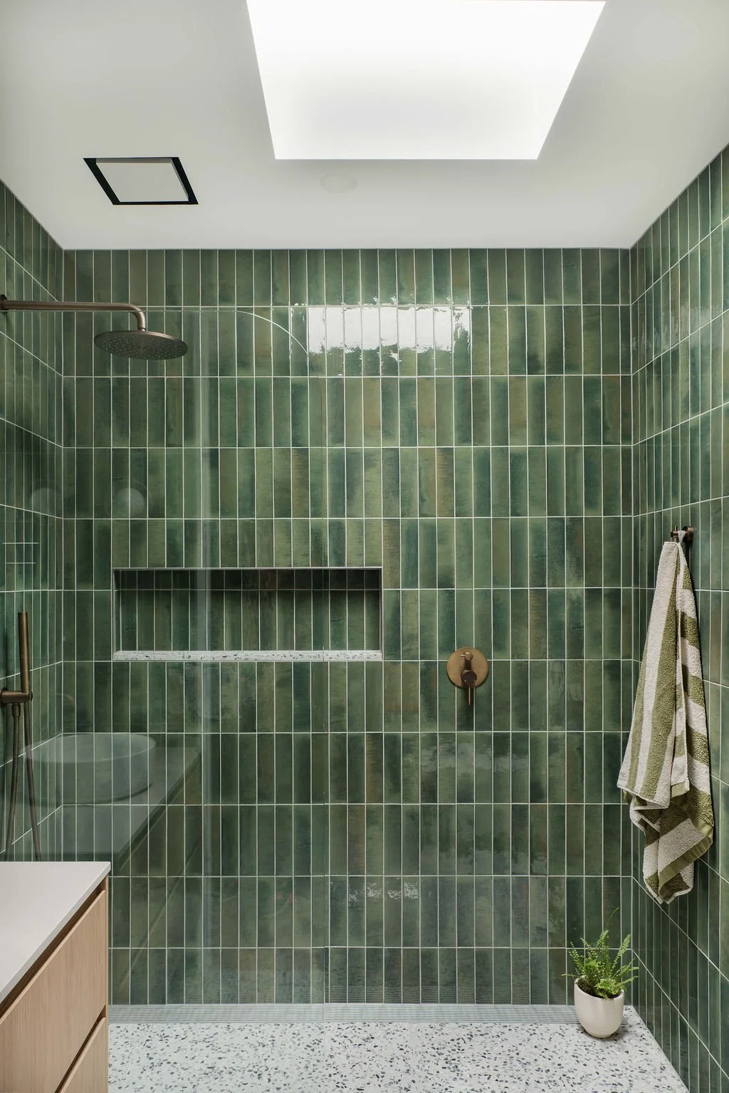The guest bathroom features mojave green tiles.