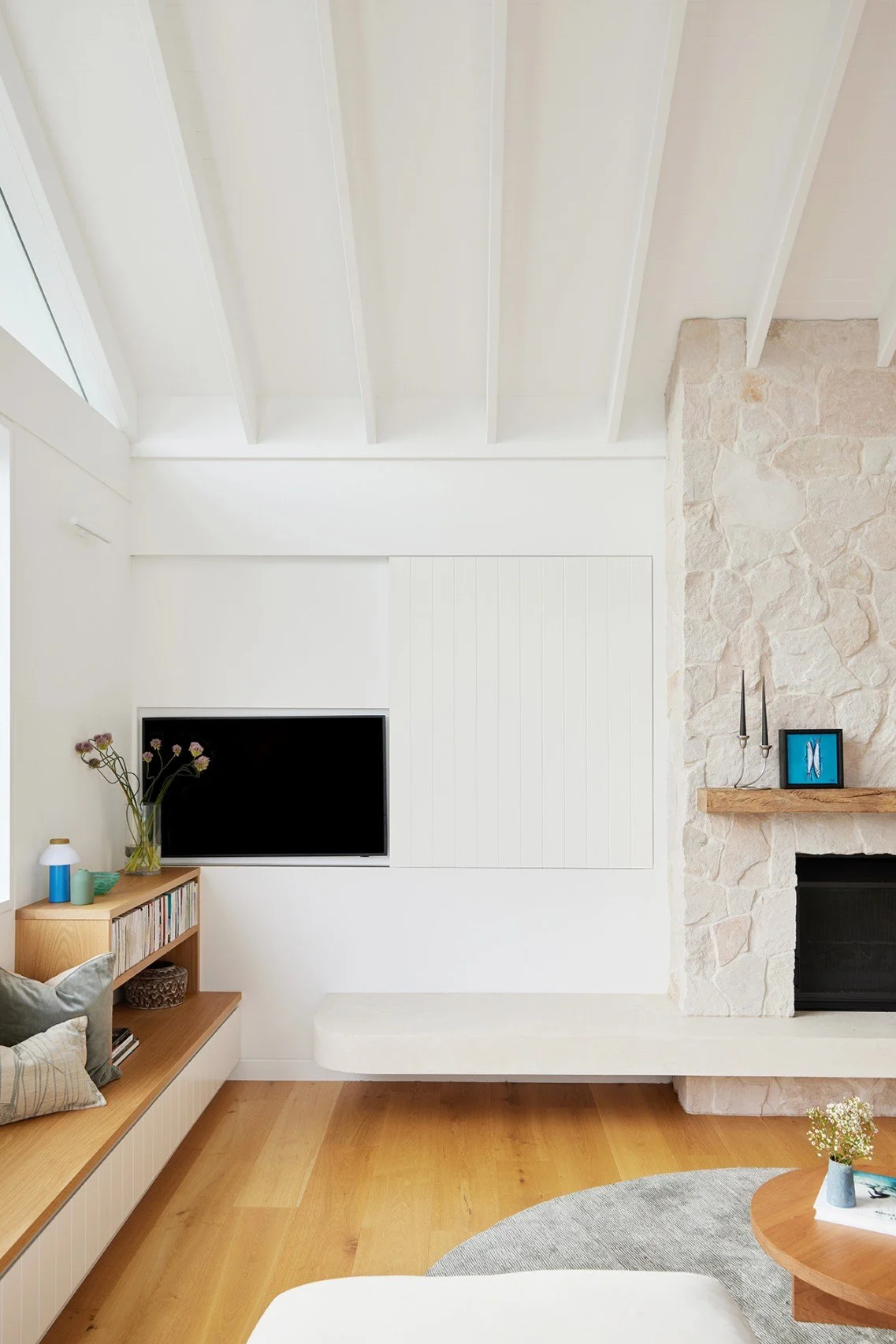 The living room presents as a family space at High Tide, with the TV exposed for use