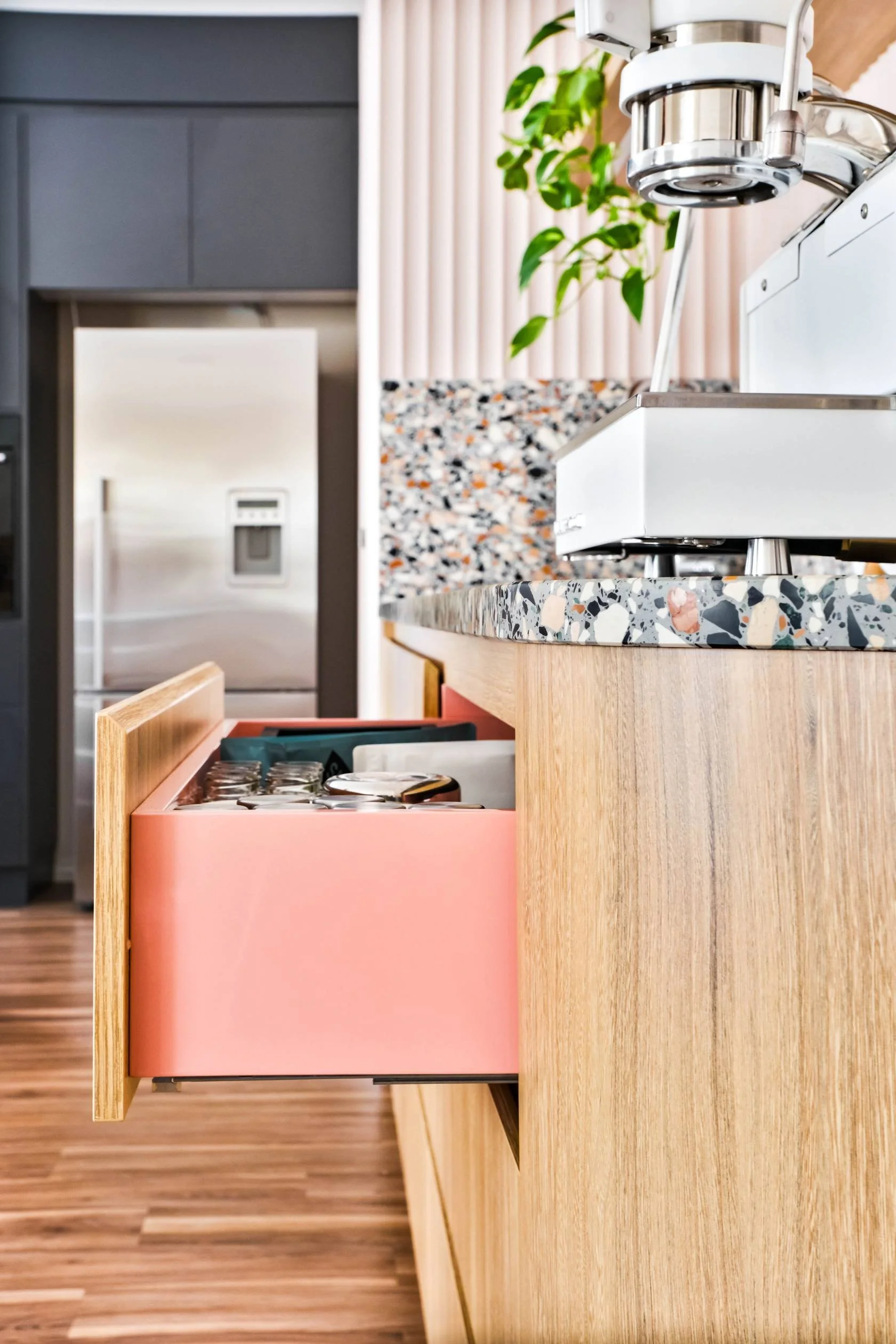 Custom oak joinery features hot pink drawer internals (Dulux Cuticle)