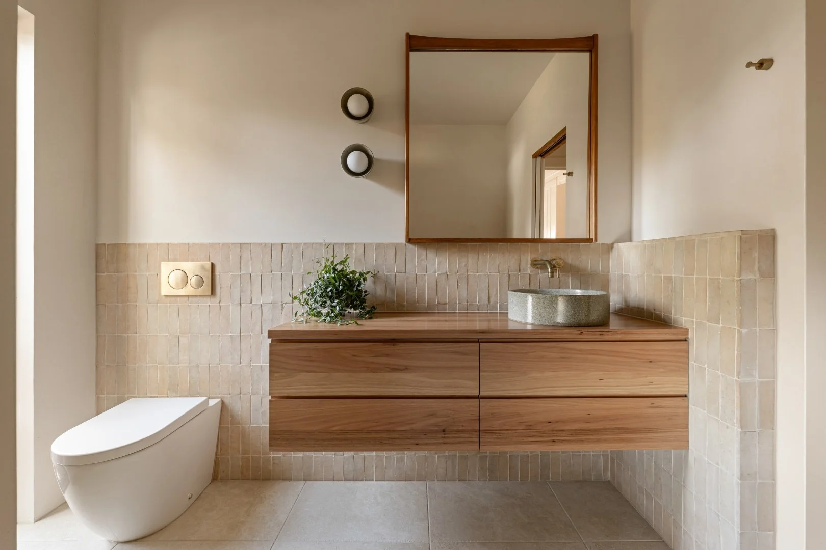 Main bathroom featuring microcement walls, custom designed spotted gum vanity and Robert Gordon lights.