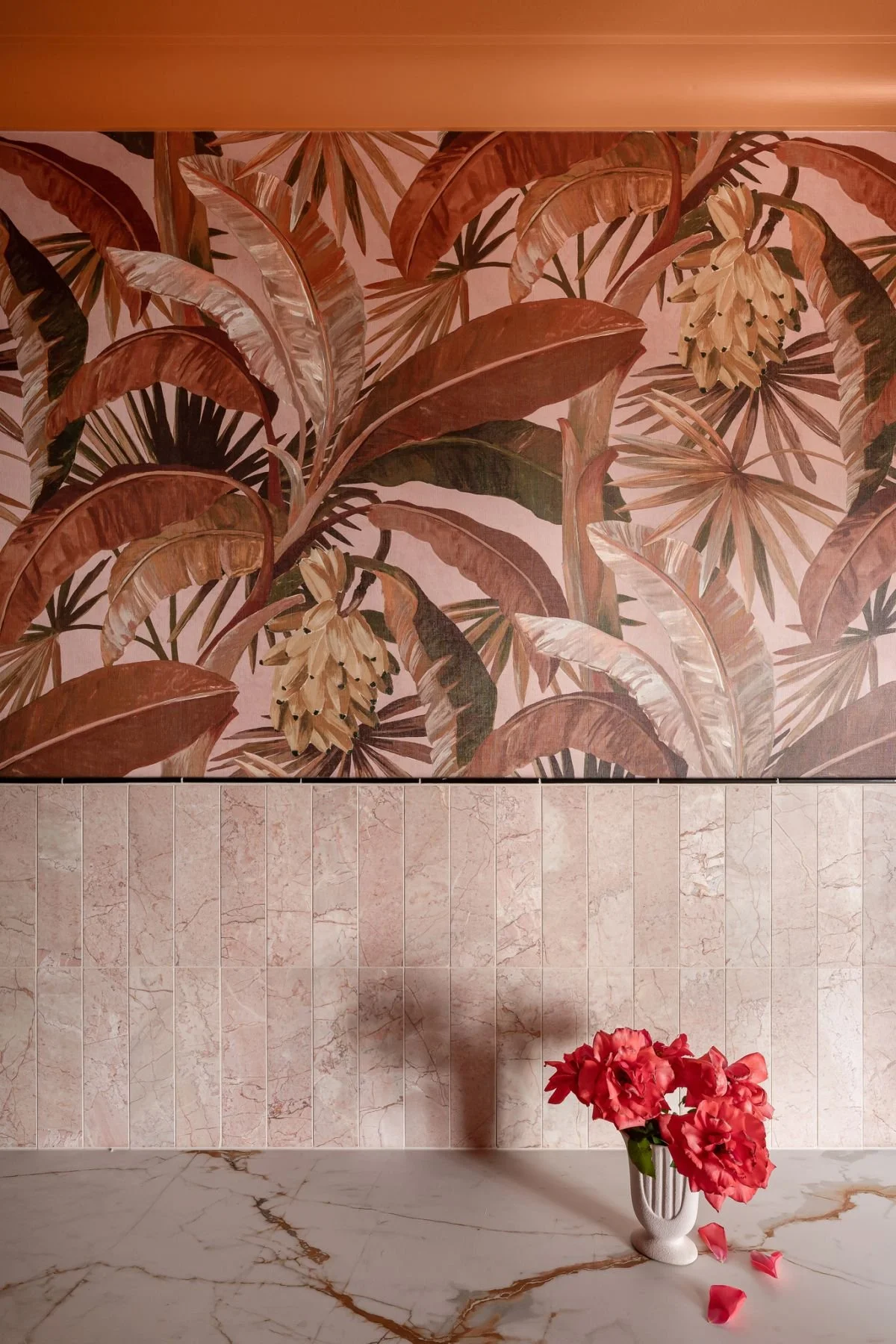 The laundry features La Palma wallpaper, Rosso Crema Honed marble splash tiles,  and a richly veined porcelain benchtop.