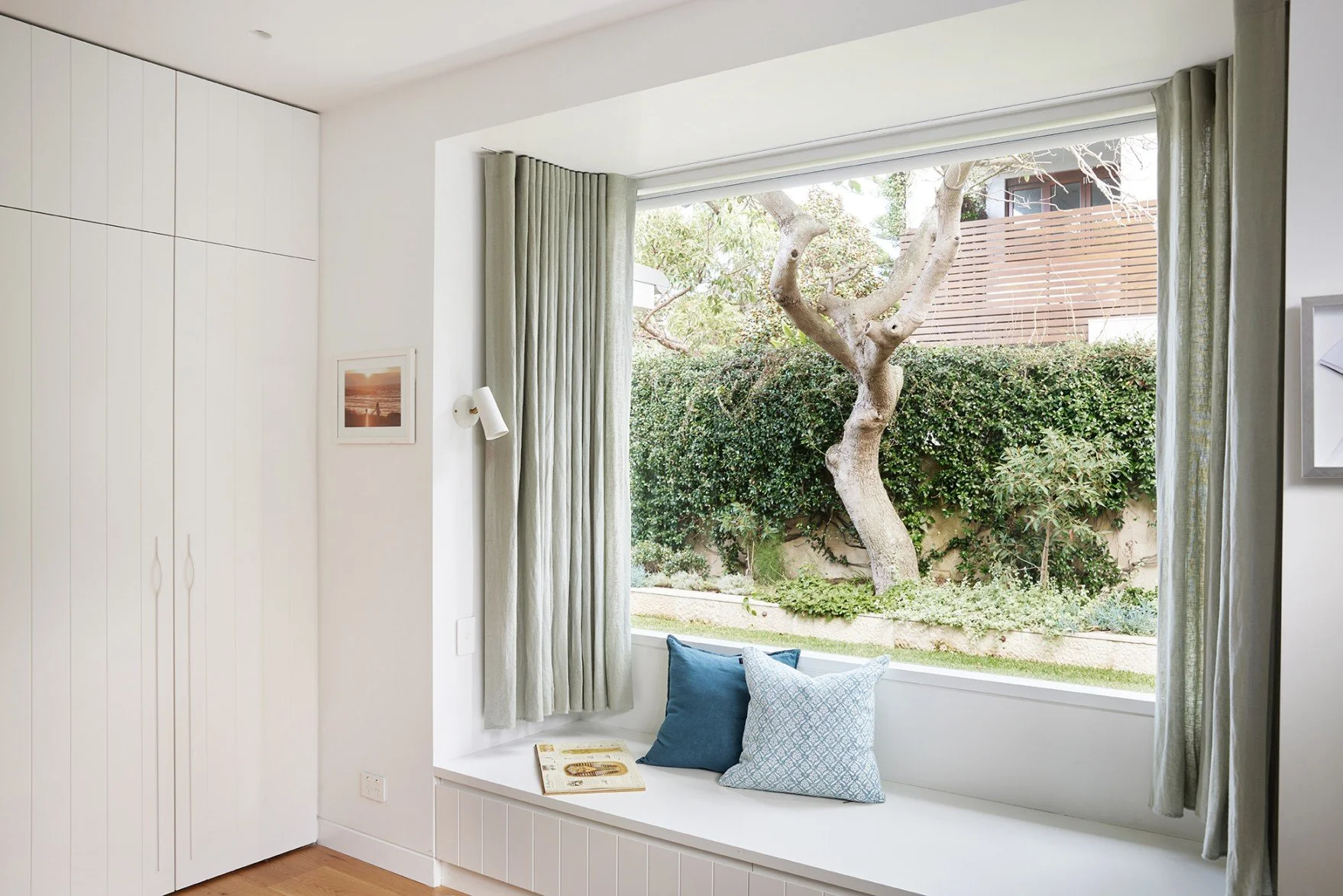 A bay window, in one of the kid's rooms at High Tide, frames the backyard beyond providing a strong connection to nature