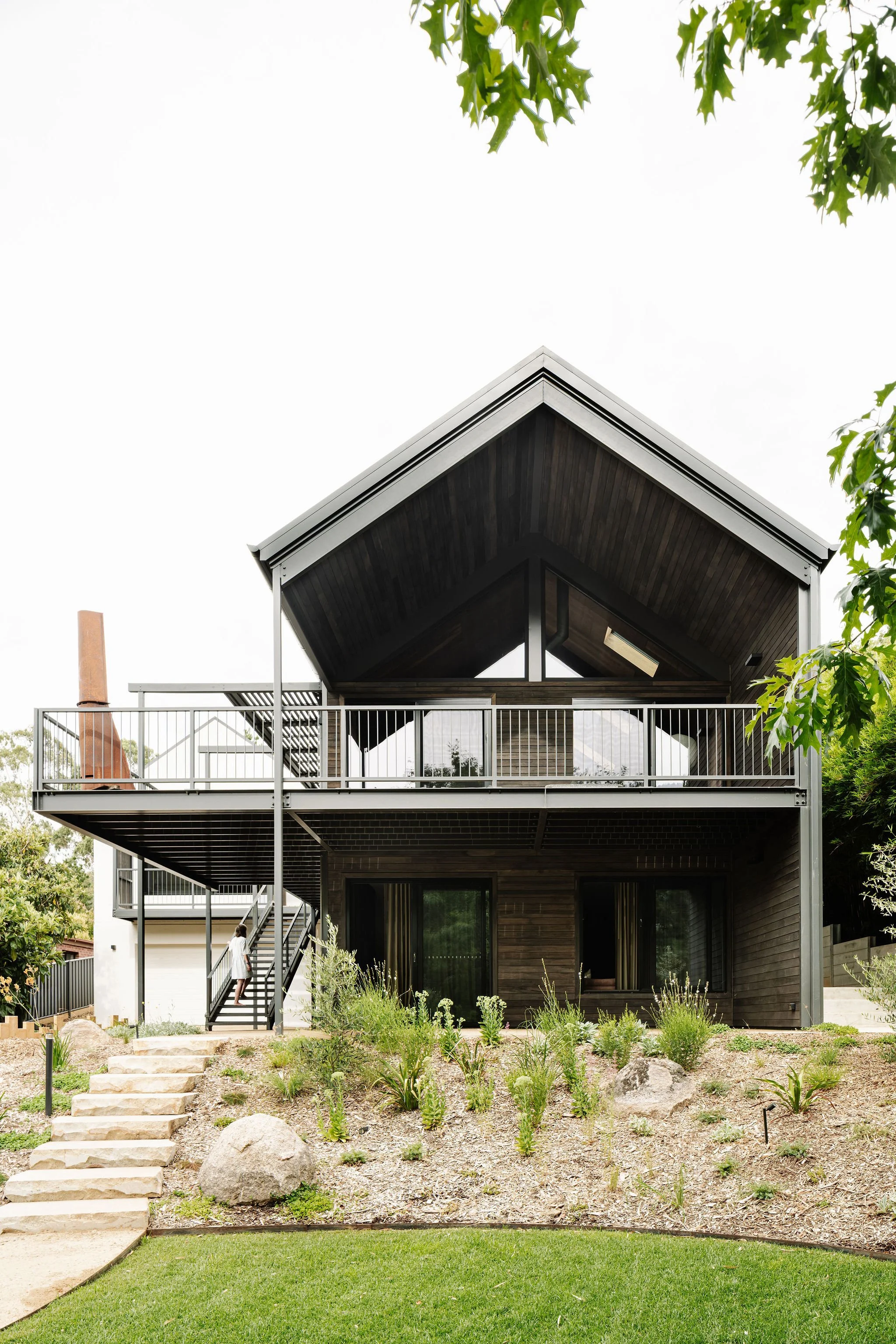 Landscaping complements the house and interior design, providing a connection to the local environment