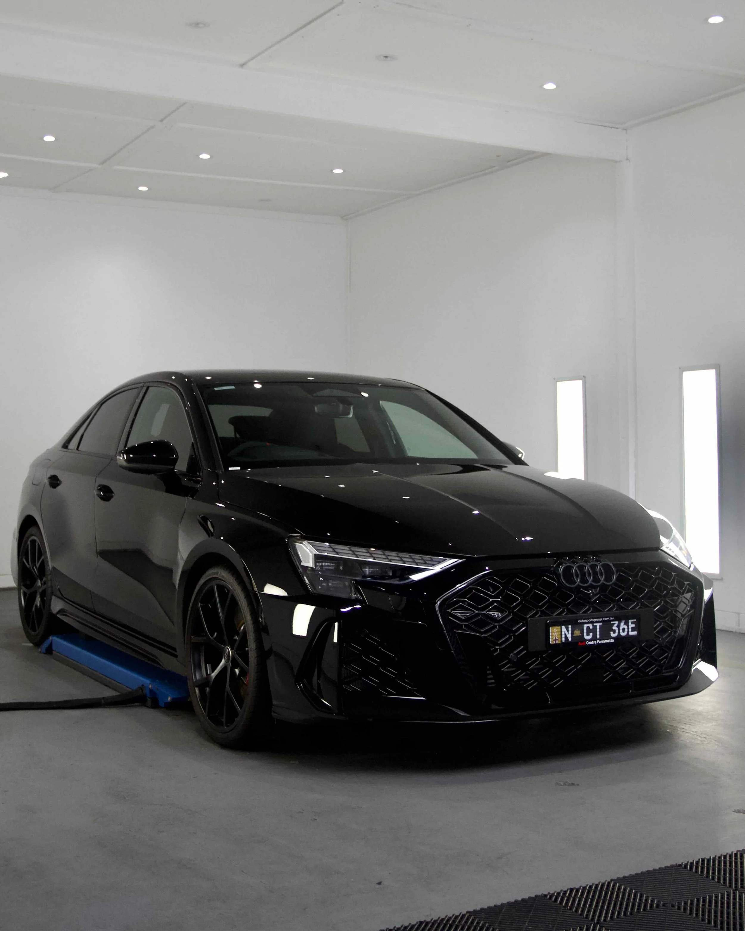 Black Audi SUV displayed inside a Detailing PPF Coating showroom