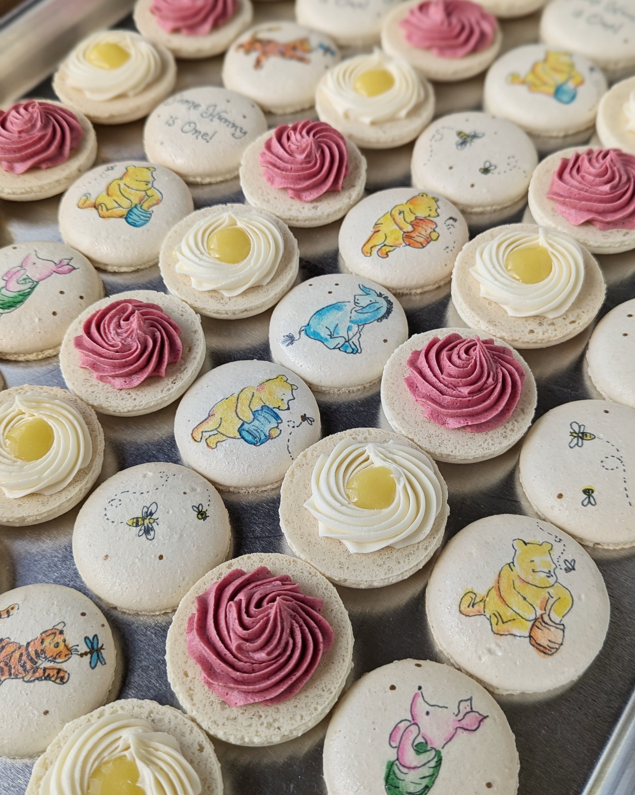 Winnie the Pooh painted macarons in raspberry and lemon for a child's birthday party in Minot, North Dakota.