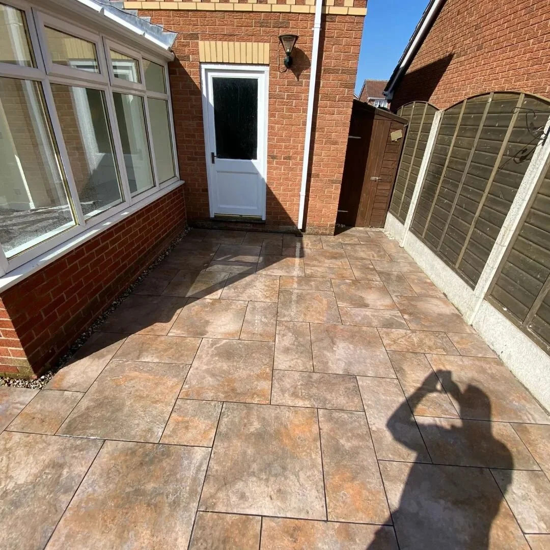 Rustic porcelain patio with a wrap around path done  last week. 👌