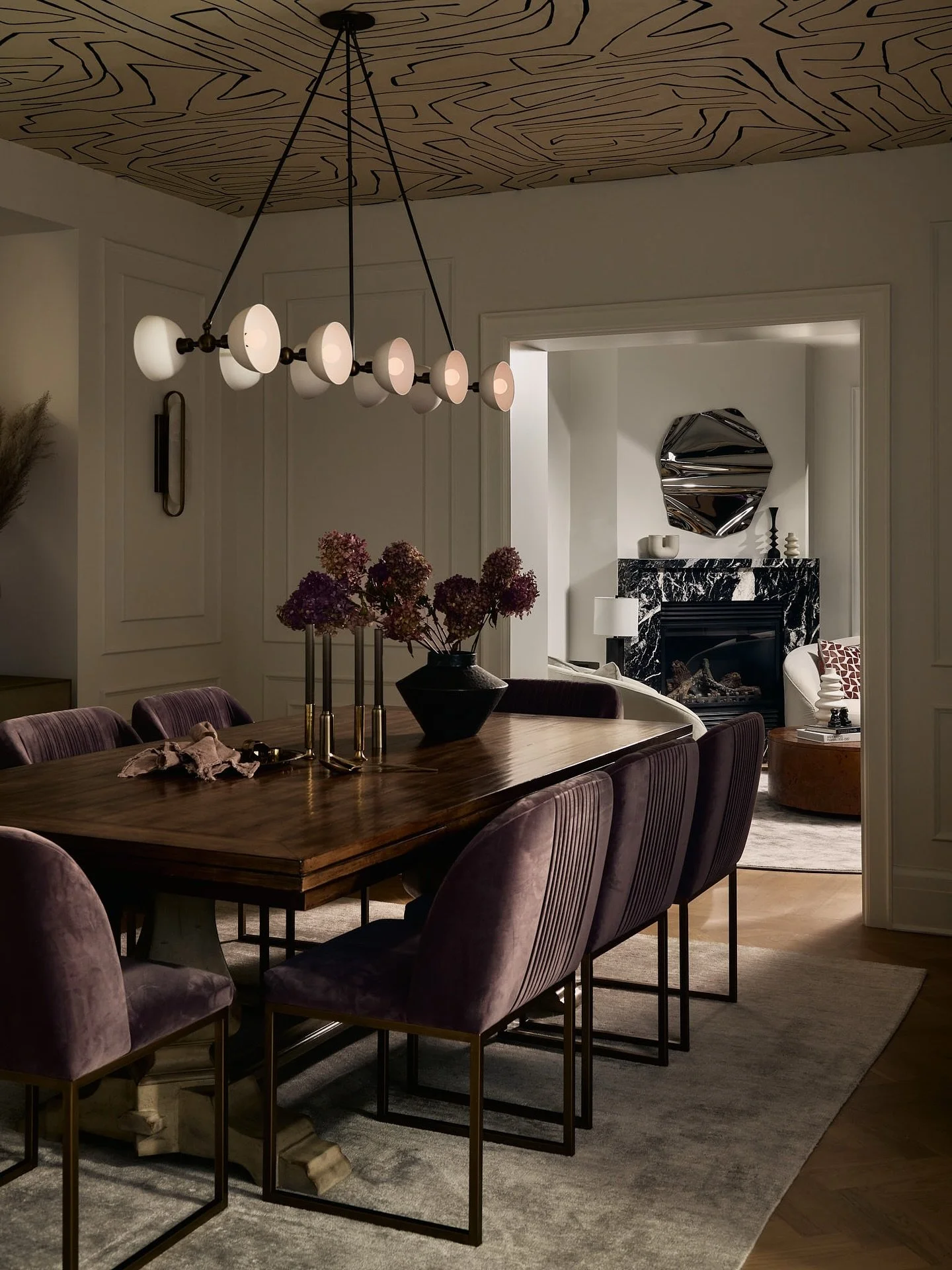 Love this dining room, enhanced with applied wall pendling, wallpaper in the ceiling, upholstered dining chairs and art!!!! You can even get a glimpse of the custom made marble mantel we made for the sitting room behind. Perfect place for hosting a m